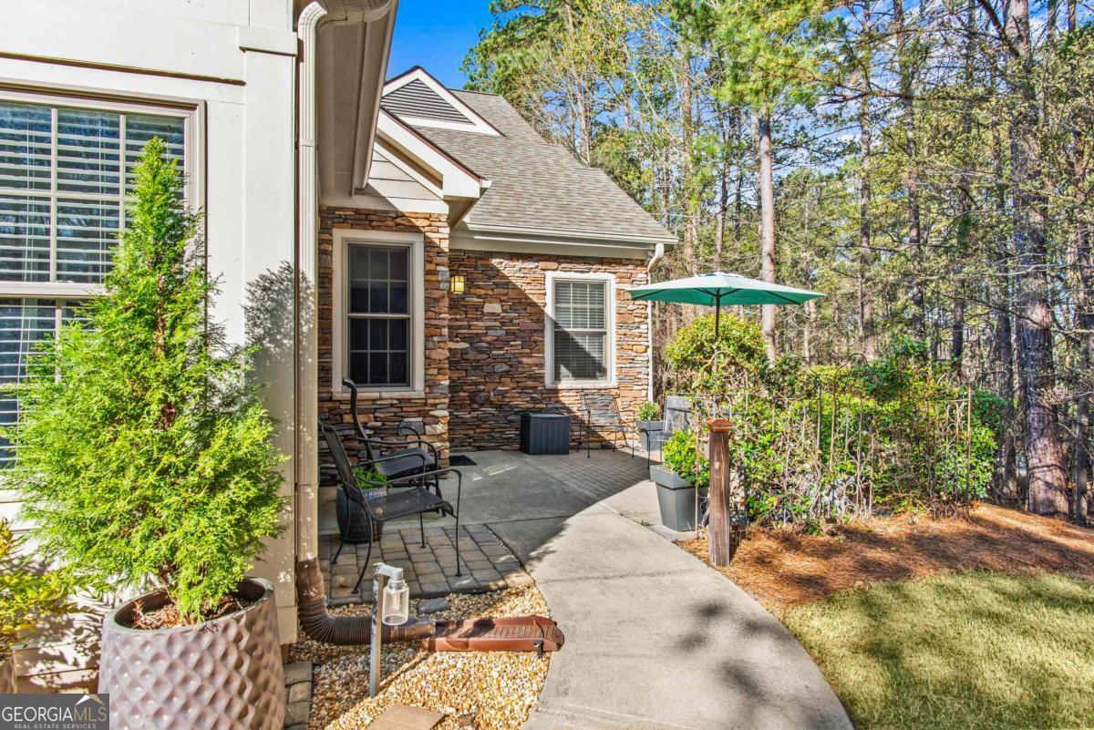 Charming One-Level Townhome in Hopeton Village at Great Waters - Reynolds Lake Oconee Nestled in the desirable Hopeton Village section of Great Waters, this beautiful two-bedroom, two-bath townhome offers the perfect blend of comfort and convenience, all on a single level. Located within a Reynolds Lake Oconee community, this home is just a short walk from the marina and community boat docks, making it an ideal retreat for lake enthusiasts. Inside, you'll find a spacious and inviting layout featuring a split bedroom plan, vaulted ceilings that enhance the open feel of the living areas. The sunroom provides a bright and airy space to relax year-round, while the private patio offers a serene outdoor retreat for entertaining or unwinding. The home also includes a two-car garage, providing ample parking and custom storage. Enjoy the exceptional lifestyle and amenities that come with living in Great Waters, including community lake access, and a welcoming atmosphere. Whether you're looking for a full-time residence, a weekend getaway or an investment rental property this charming townhome is a must-see!