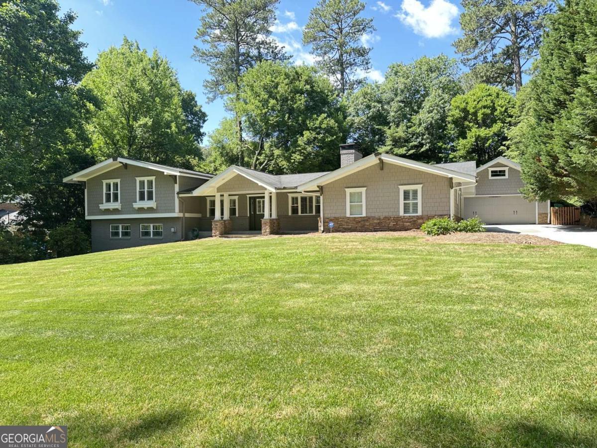 Exceptional opportunity to own a beautifully renovated home, on a quiet street in the highly sought after Oak Grove Elementary and Lakeside High School district. This comfortably chic home is designed for how people live, work, play today. This unique home seamlessly integrates functional spaces with a private outdoor oasis, creating the perfect backdrop for both everyday living and grand entertaining. Step inside from the welcoming front porch and be greeted by an open airy great room with vaulted ceilings with an effortless flow to the heart of the home, a well-appointed kitchen with custom cabinetry and expansive island, perfect for entertaining. Step out to a beautiful patio, extending the living space outdoors to a private fenced backyard - an ideal setting for relaxing, al fresco dining and creating lasting memories for all ages. Escape to the oversized primary suite, a sanctuary complete with a spa-inspired bath. Three additional bedrooms and three renovated baths provide ample space for everyone. The lower level features an expansive family room with a striking stone fireplace and real sandstone flooring, along with another potential bedroom, that can also be used as a private office - perfect for those that work from home. Conveniently located on this level is a laundry room and another half bath. Built in desks and murphy bed are amazing. An actual detached oversized two-car plus garage that offers endless possibilities - cars protected from the elements with storage galore above. This oversize garage could easily be converted to a state-of-the-art home gym, an artist studio, or even an in-law suite....the possibilities are endless. You'll love the proximity to all the award-winning schools (both public and private), parks, playgrounds, pools and the new multi-use path. Phenomenally easy access to the Atlanta Airport, CHOA, Emory, CDC, I85, Buckhead, Midtown, and beyond. Must See!
