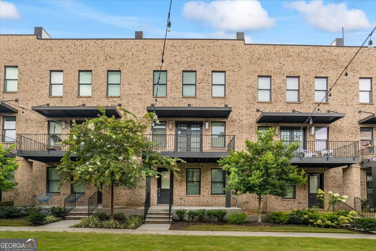 Gorgeous Townhouse offers a private roof top deck with picturesque views of the city and balcony or patio on each floor. Offering hardwood flooring, open concept kitchen with large island featuring stone counter tops, gas range with a hood vent and under counter microwave, dishwasher & refrigerator; a master suite with a large tile shower, double vanities and large walk-in closet. Tons of natural light flow from the windows with 10' ceilings on the main offering a spacious floor plan. The townhome features 3 bedrooms and 3.5 baths and private two-car garage. Call for a private viewing! Info from the Developer: This 61-townhome community and BeltLine Connector has easy access to premier new developments on Atlanta's Westside such as Echo Street West, Project Granite, and Westside Paper. Sitting in the heart of West Midtown, Ten29 West is conveniently located near major local attractions, such as the largest park in Atlanta - Westside Park, Microsoft's proposed campus, Mercedes Benz Stadium, State Farm Arena, Atlantic Station, World of Coca-Cola, and more. Most pictures were taken when the townhouse was built in 2022. Available for immediate move-in upon approval & payment.
