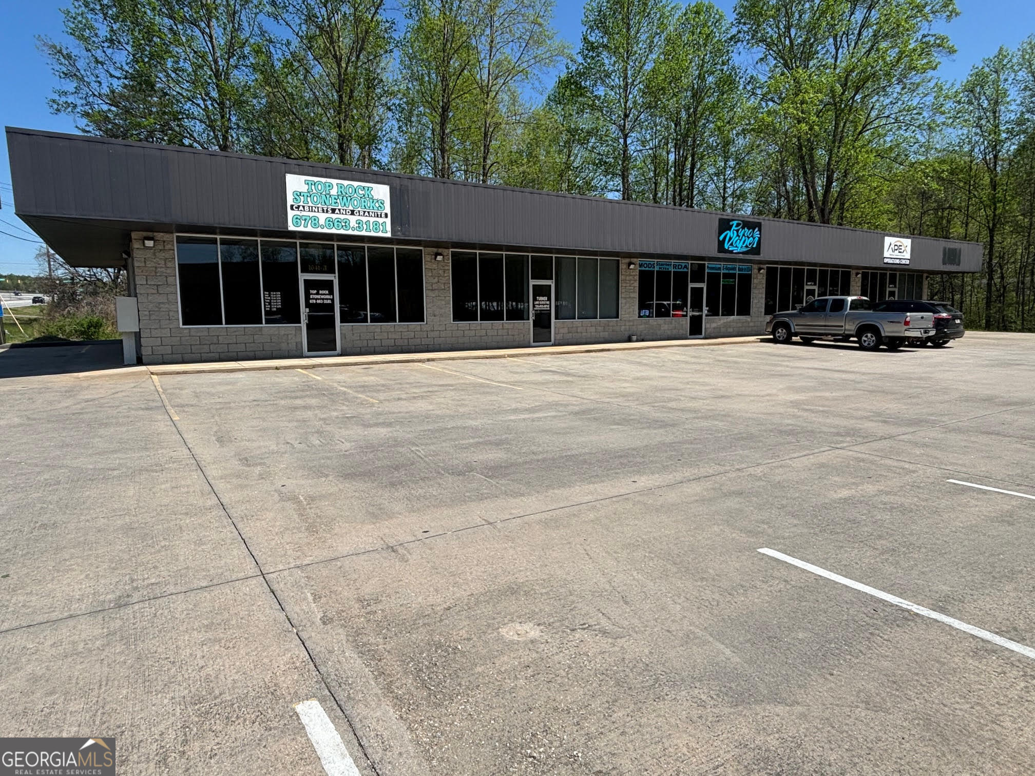 5 Unit Commercial Building located on the heavily traveled Hwy 129! Whether you are looking for an income producing rental property, or an opportunity for your own business, this property has quite a bit to offer. Wonderful visibility and plenty of paved parking add to the desirability of this multi-unit building. 4 of the 5 units are currently occupied so you can potentially hit the ground running with income production. There are a variety of layouts with the units with some offering more open floorplans and others being set currently to accommodate an office type atmosphere. Each unit does also come with its own private half bath. Don't miss out on this great property situated on a 0.76+/- acre lot just outside the Cleveland City Limits! Public water and sewer connected!