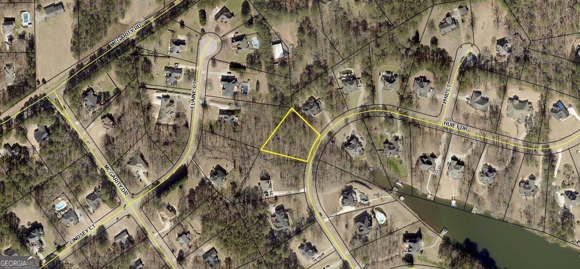 Fantastic opportunity for anyone looking to build their dream home in the beautiful neigborhood of Lake Dow North with seasonal views of the Lake. You will appreciate the proximity to top-rated schools such as Ola High School. This makes the area perfect for families seeking quality education options for their children, without the hassle of long commutes. The proximity to McDonoughCOs growing downtown district is also convenient, offering a nice blend of quiet residential living with access to local shops, dining, and entertainment. Lot is located next to 795 Huiet Dr., McDonough, Ga