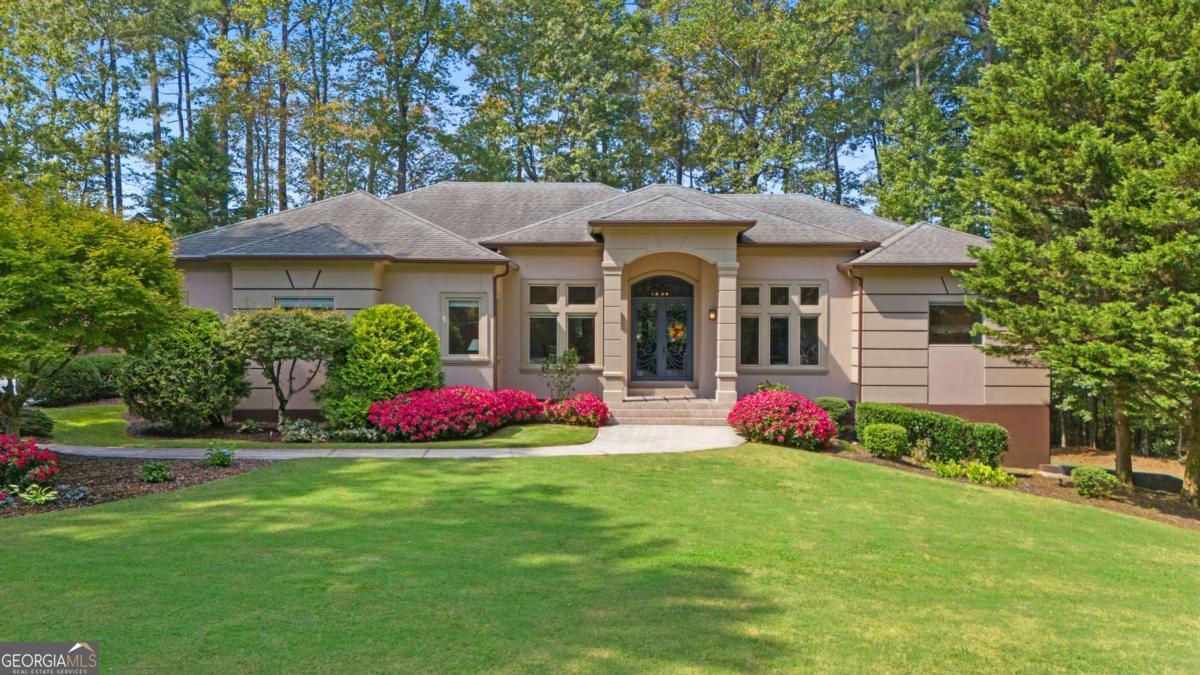 Well-Crafted & Custom-Built Contemporary Ranch on 1.4 Private Wooded Acres! This exceptional home is truly one-of-a-kind-thoughtfully designed, impeccably maintained, and beautifully finished throughout. Soaring 12 ft. ceilings on the main level and 12ft. ceilings on the terrace level are enhanced by elegant custom trim and molding, creating a sense of light and luxury at every turn. At the heart of the home, the chef's kitchen impresses with extensive custom walnut cabinetry, high-end stainless-steel appliances, and a built-in commercial-grade refrigerator/freezer. The kitchen flows seamlessly into the keeping room and family room, centered around a custom fireplace, with French doors opening to a spacious covered upper level terrace with balustrade, and stairway-perfect for morning coffee or evening relaxation. The main level also offers: Private office and full custom bath, ideal for working from home. Luxurious primary suite with double walk-in closets and a spa-quality bath featuring dual vanities, oversized shower, and whirlpool tub. Two additional bedrooms, with a custom bath. Well-appointed laundry room with built-in cabinetry, wash basin, and washer/dryer. Freshly finished 2-car garage with brand-new poly-tek flooring. The terrace level is designed for entertaining and everyday comfort, featuring: 12ft. beamed ceilings, Full kitchen and dining area, Family room and den, Soundproof theatre and music room with custom built-in's, Large bedroom with private custom bath, Bonus and exercise rooms, plus an additional full bath, French doors open to a private covered patio and courtyard. Outdoors, unwind in the gazebo, gather around the firepit, or enjoy the beautifully refreshed landscaping. Additional highlights include a private gated entry, freshly painted exterior, new "energy-efficient Trane HVAC systems on the main level", an outbuilding for extra storage, and countless custom upgrades. This rare property offers unmatched privacy, elegance, and livability-truly a home you'll be proud to call your own!