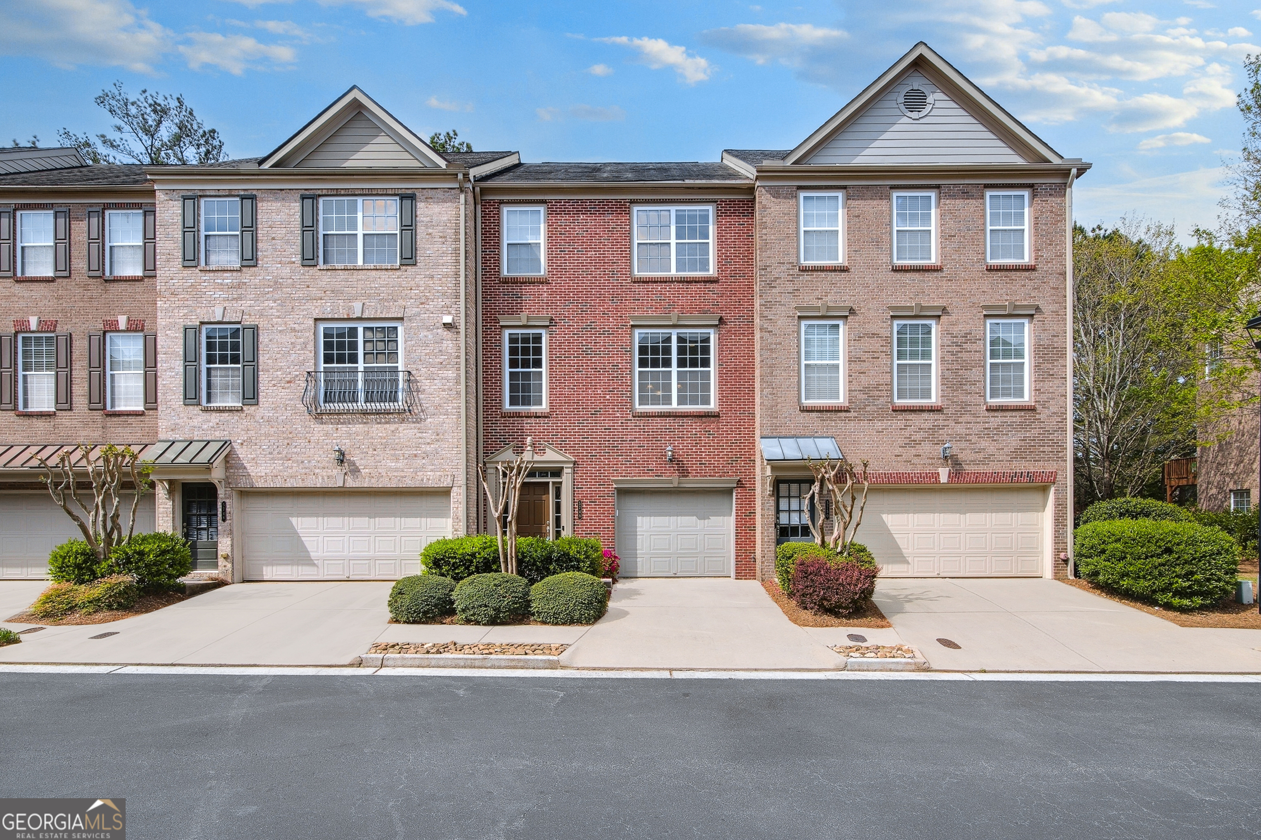 Welcome to this stunning 3 story, 3 bedroom, 3.5 bath townhome offering an open layout and wonderful outdoor living in highly sought-after Norcross/Peachtree Corners, close to downtown Norcross, Town Center and the Forum! This warm and welcoming home with an abundance of natural light has gorgeous woodtone laminate floors and a gas log fireplace facing into the open living and dining space (great room) creating a warm and inviting living space. The kitchen has an abundance of cupboard and counter space, featuring a large island with extra storage and seating. The breakfast bar overlooks the living and dining space which has a French door onto a huge deck that is perfect for outdoor entertaining! Upstairs are two spacious bedrooms and two full baths, including a luxurious primary suite with double vanities, a soaking tub, separate shower and two linen closets. On the entry level is the third bedroom and full bath that can also serve as an office or workout room as well as a laundry room. It even has a walk out to the backyard. Located off Peachtree Industrial Boulevard. HIGHLY MOTIVATED SELLER WILL CONTRIBUTE TO CLOSING COSTS.