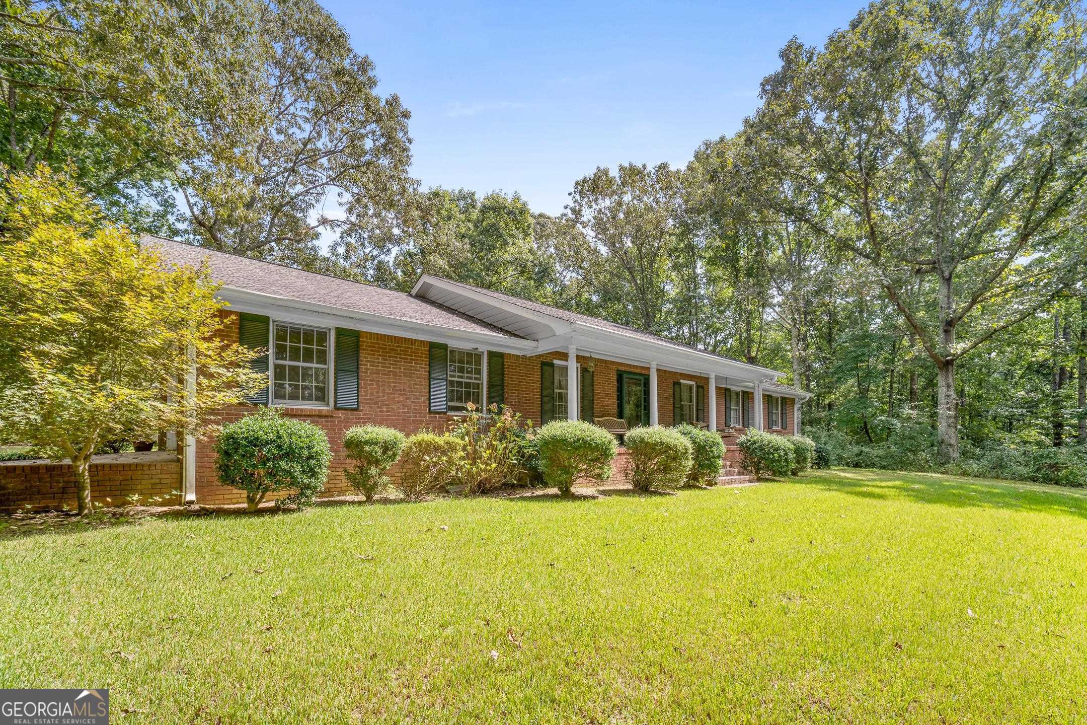 Welcome to this well maintained spacious all brick ranch home on your private oasis of 10 useable acres,. Only 2.3 miles from the interstate yet hidden up the hill in the wooded pasture. Inside offers beautiful hardwood floors, an eat-in kitchen,and an oversized primary suite. The formal dining room and living room with fireplace is great for entertaining. There is a large laundry room off of the country style kitchen with ample cabinet /counter space and stainless steel appliances. As you step out the back door, you can enjoy evenings on the screened porch overlooking the wildlife and changing seasons. Outside you will find a two car attached garage and detached single garage, fenced in pasture areas, deer stands, all while being minutes from the interstate. Close to shopping and dining and quick commute to the airport.