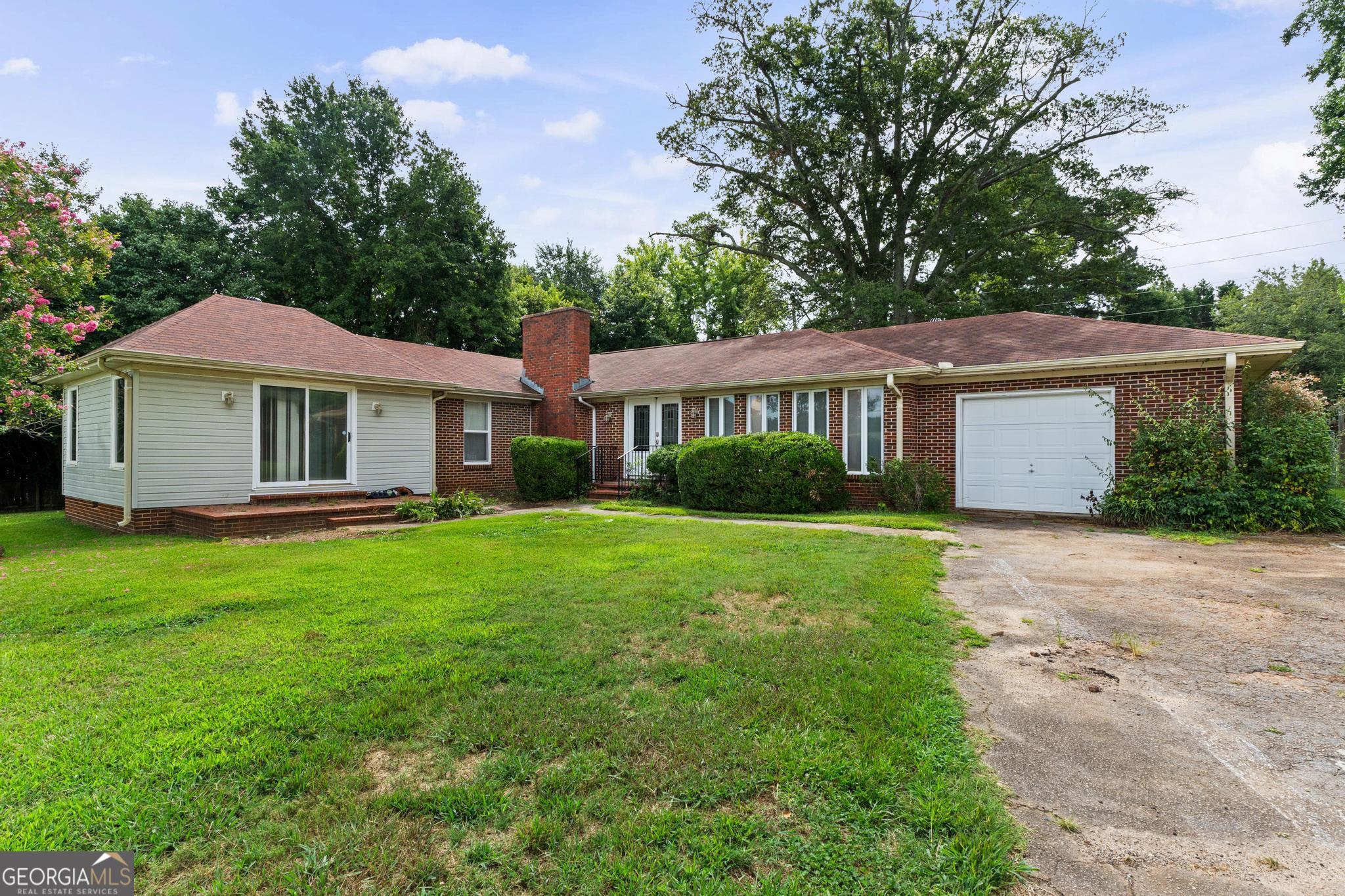 GREAT LOCATION & POTENTIAL COMMERCIAL! Brick Home that would make a great Office Space for any business, Florist, Personal Care home, Day Care! Ready for you to have Zoned for your business! Large Spacious Great Room w/fireplace, Formal Dining Room, 3 Bedrooms and 2 Full Baths! Oversized 1 car garage, Fenced back yard plus storage building! Home is on Sewer & county water plus there is a well available too! HVAC only appx 3 years old & Brand New Hot water heater! Only Minutes into Griffin, close to Shopping, Hospital & Restaurant's! Don't miss this Great Property and the Opportunity for you to make this your own!