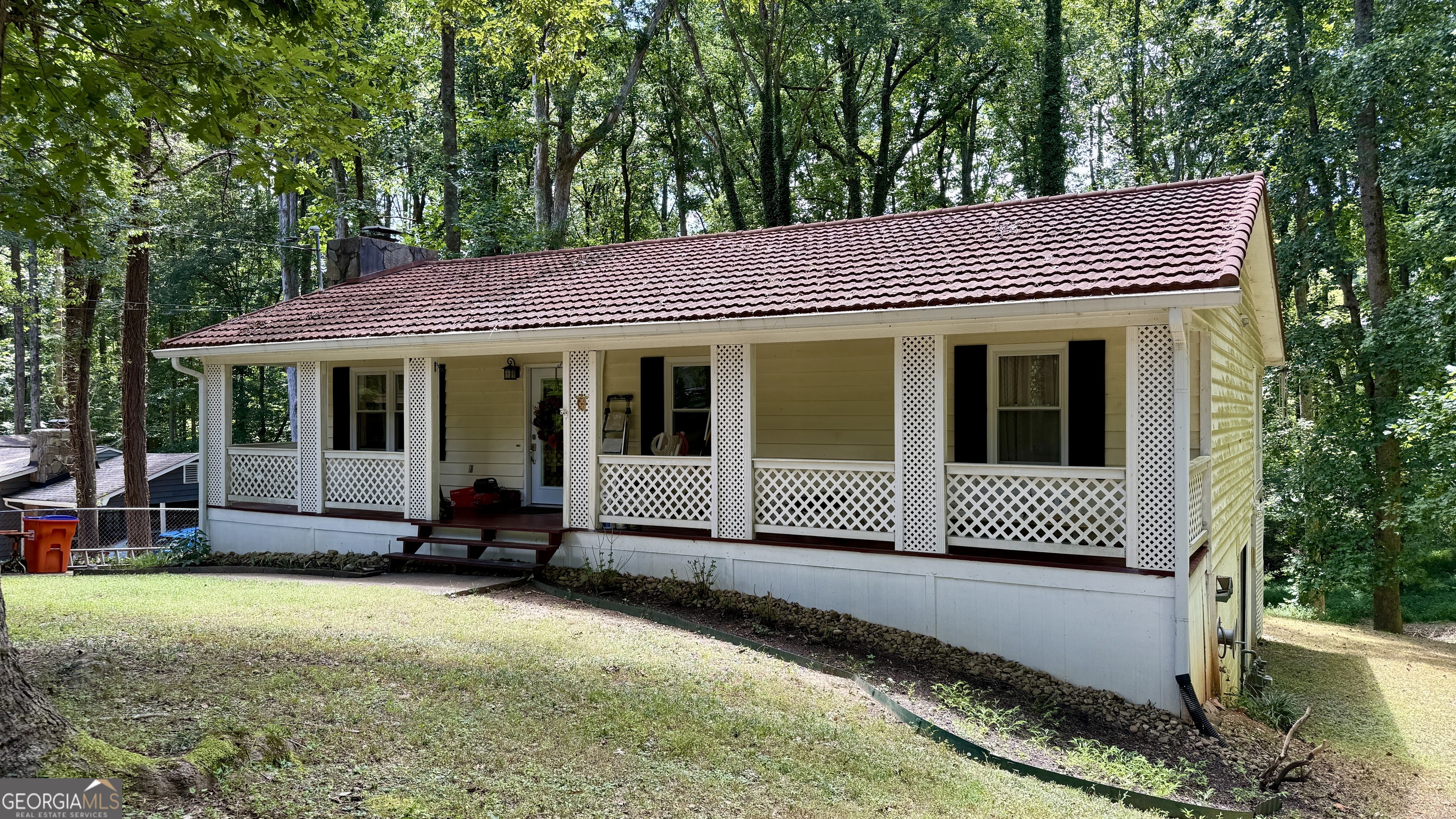 Charming Mountain-Style Ranch with Sunroom, Walkout Basement & Bonus Storage! Well-built and beautifully maintained ranch home on a quiet dead-end street with no through traffic-just minutes from shopping, dining, and interstates, yet nestled in a peaceful, retreat-like setting. Located in the highly sought-after Creekview High, Creekland Middle, and Avery Elementary School district. This home features a Gerard fireproof metal roof designed to look like clay tile, locally sourced cedar siding, and gorgeous Brazilian teak hardwood floors throughout most of the interior. The expansive sunroom is a showstopper, offering walls of windows and rare purpleheart hardwood flooring-perfect for relaxing or entertaining. Enjoy a fully updated bathroom with double vanities, tile flooring, and a new tub. The kitchen includes solid wood cabinetry, and appliances are included. One bedroom is currently used as a custom walk-in closet, easily converted back to a full bedroom if desired. New vinyl windows, extra insulation, and quality construction throughout ensure year-round comfort. The home also boasts a full walkout basement with excellent potential for finishing, storage, or workshop use-plus a large shed located beneath the sunroom, providing even more bonus storage space. This unique home blends character, craftsmanship, and convenience-all in a top-rated school district.