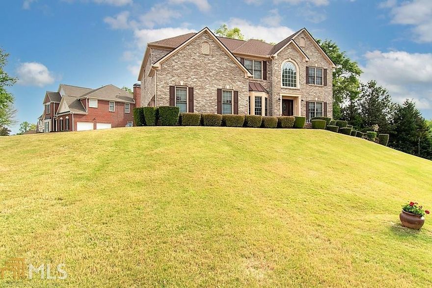 This exquisite five bedroom four full bath home sits on a picturesque hill. The curb appeal of this beauty is superb upon entering this lovely subdivision.  You cannot miss it!  This beautiful home is located in the highly sought after Eagles Ridge Subdivision in Lithonia.  It features a new, large gourmet kitchen with lots of counterspace, a large island with plenty of cabinets overlooking the family room that embraces a warm, cozy fireplace.  French doors off the kitchen lead to a comfy deck perfect for entertaining or just a lovely dinner for two. The kitchen features all new, state of the art appliances.  New HVAC, water heater, and roof all come with a warranty.  The basement is unfinished and is ready for your creative touch. Are you ready to make it your own?  Hurry, this one will not last long!  Please schedule via ShowingTime.