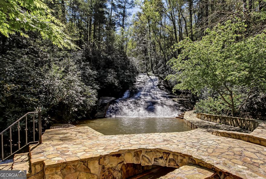 Discover a premier investment opportunity with this stunning 100+ acres commercial mountain resort, located in the charming town of Clayton, Georgia.  This distinguished property has been a sought-after wedding venue for over two decades and now presents an exceptional opportunity for corporate retreats, social events, and family vacations.  Property highlights include expansive land, elegant event facilities, luxurious accommodations, recreational opportunities, and investment potential.  This expansive estate offers a breathtaking natural landscape featuring serene creeks, awe-inspiring waterfalls, a large trout stream, and a pristine lake.  The diverse topography includes a dramatic mountaintop building site with panoramic views extending across three states.  The resort provides multiple event spaces including a grand ballroom capable of accommodating over 250 guests.  With conference and meeting rooms available, this venue is ideal for both corporate gatherings and social celebrations.  The property includes 28 well-appointed suites providing ample lodging for guests.  Whether hosting a large conference or a small family retreat, the accommodations ensure comfort, luxury, and privacy.  Enjoy a range of outdoor activities with extensive hiking trails winding throughout the property, offering tranquil walks and adventurous explorations.  With its established reputation and versatile amenities, this resort presents a prime opportunity for overnight accommodations while providing guests with an unparalleled mountain experience.  This exceptional estate blends natural beauty with sophisticated amenities, making it the perfect setting for both corporate and personal retreats.  Don't miss your chance to own this remarkable mountain resort and continue its legacy of elegance and excellence.
