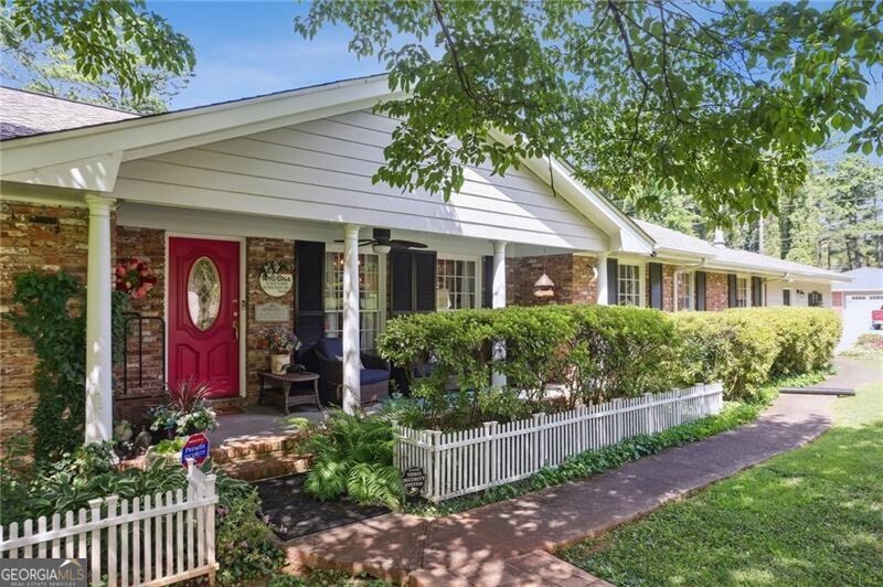 SUPERB 4 sided brick ranch in West Side Elementary School district and easy access to Kennestone Hospital and The Walker School! GORGEOUSLY landscaped almost 1 acre corner lot on a private street. Renovated kitchen with two toned cabinets and stainless appliance package. TONS of living space including a living room, a huge sunroom on the back AND a huge den with wetbar. Partial basement that is unfinished and perfect for storage. Newer roof, 2 car side-entry garage, custom koi pond, real oak hardwoods throughout, and a deck on the rear.