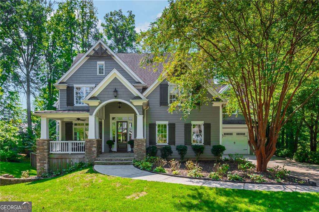 Welcome home to 150 Shady Grove Lane, a stunning custom residence by Ken McGarry Homes. This complete redesign offers the rare combination of a gorgeous wooded lot and unbeatable walkability-right in the heart of Downtown Alpharetta. This property is spacious on nearly a half-acre with a long, level driveway and perfectly set-back home to provide a large front yard. The backyard is truly captivating, featuring a 25-foot setback and preserved tree canopy with gorgeous oaks and hickories. The vaulted front porch sets the tone, welcoming you inside to a spacious home office with gas fireplace and serene views of the lush front yard and inviting porch. The thoughtfully designed kitchen is a true centerpiece, featuring a large seated island paired with contrasting honed granite counters, a gorgeous tile backsplash, and a gas range with griddle beneath a covered vent hood. A pot filler and farmhouse sink framed by windows overlooking the outdoors add both beauty and function. The dining area flows seamlessly into the family room, where a coffered ceiling, stone fireplace with hearth, custom built-ins, and expansive front-to-back windows create a light-filled space perfect for gathering. The main-level guest suite offers the ideal arrangement for generational living, blending comfort and convenience for extended family or visitors. A charming "friendship door" opens to a slate-accented hallway and mudroom, leading effortlessly to the casual porch room and the spacious three-car garage. To complete the main level and seamless flow, enjoy the expansive screened-in porch room designed with double fans, ample space for dining, lounge seating, and movie nights or football season -perfect for year-round gatherings. Upstairs, you'll be greeted by a large, light-filled bonus room-an incredibly flexible space that can serve as a secondary living room. The primary suite impresses with a beautiful coffered ceiling and a spa-like bath featuring a frameless glass shower, free standing tub with polished feet, and a spacious walk-in closet. Three additional secondary bedrooms complete the upper level, each designed as a custom suite with direct bath access for comfort and privacy. From the moment you step inside, you'll feel the custom touches that define this home-spanning over 4,000 square feet across two thoughtfully designed levels. The unfinished basement provides a blank canvas awaiting your personal design and future expansion.