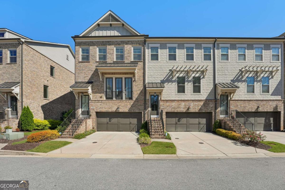 Experience luxury living in this stunning multi-level, full-brick townhome with a basement located in the highly desirable Park at Paces Ferry. Offering a prime location, this home puts you just minutes from Cumberland Mall, Truist Park, The Battery, Vinings at Jubilee, and a wealth of shopping, dining, and year around entertainment options. Everything you need right at your fingertips. The open-concept main level is designed for both comfort and style, featuring a built-in buffet and dry bar area, perfect for entertaining. A floor-to-ceiling tiled fireplace serves as a cozy and elegant focal point, while upscale fixtures and finishes elevate every detail. This level also includes a dedicated office or flex space, a spacious dining area, and a chef's kitchen complete with an island breakfast bar, stainless steel appliances, pantry, and a herringbone subway tile backsplash. From the main living area, step out to the covered balcony for relaxing evenings or morning coffee. Upstairs, the luxurious primary suite boasts a sitting area, private balcony access, and a spa-like en-suite with a double vanity, soaking tub, walk-in shower, and a large closet. An additional en-suite bedroom and a conveniently located laundry room stubbed for a sink, complete the upper level. The lower level offers private access from the garage and includes a bedroom with a sitting area, covered balcony, and a full bathroom, perfect for multi-generational living, guests, or roommates. The unfinished basement on the ground level provides endless possibilities to create your dream space, whether it's a media room, game room, home gym, or entertainment hub while adding instant equity as plumbing and HVAC are already ran for easy finishing. The back patio opens to a fenced backyard, ideal for pets or enjoying a bit of outdoor privacy. Yard maintenance included for a maintenance free lifestyle!With its flexible layout, roommate-friendly design, and incredible location, this townhome delivers modern living with convenience and versatility, making it a perfect place to call home or a smart investment opportunity.