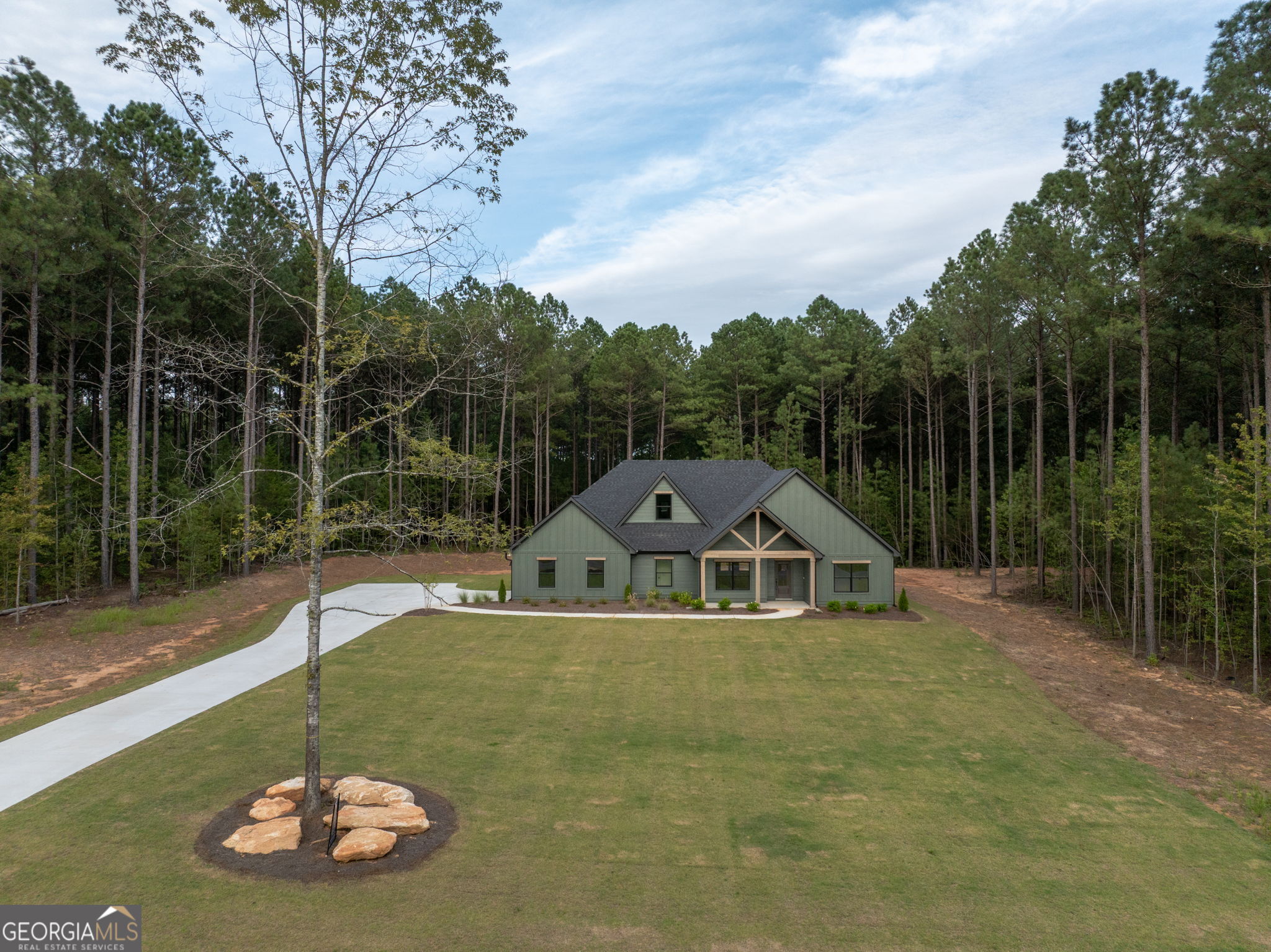 Introducing the newly styled "Theodore Extended" - now featuring an eye-catching open gable front porch! This stunning 5-bedroom, 4-bath home is move-in ready and fiber internet is available! Nestled on a private, wooded 3-acre lot, this home blends modern convenience with classic country charm. Enjoy peaceful outdoor living on the spacious rocking chair front porch and oversized covered back patio - perfect for entertaining or relaxing with a view of the trees. Inside, the foyer welcomes you into a thoughtfully designed layout with a formal dining room accented by custom trim and a large family room featuring an 11' ceiling and stylish electric fireplace. The gourmet kitchen offers ample cabinetry, quartz countertops, a designer tile backsplash, a large island with glass pendant lighting, stainless steel appliances, and a generous walk-in pantry. The main-level owner's suite is a true retreat with a large walk-in closet, tiled shower, freestanding soaking tub, dual quartz vanity, and private water closet. Also on the main floor are three additional bedrooms and two full guest baths, offering plenty of space for family or visitors. Upstairs, you'll find a versatile fifth bedroom or guest suite with its own full bath - ideal for in-laws, teens, or a private office. Additional highlights include cement board siding, architectural shingles, Low-E windows, spray foam attic insulation, and an attached two-car garage. Don't miss the smart home features: keyless deadbolt, select smart switches, video doorbell & more. Builder requires a 2% construction deposit and offers a $2,500 credit with use of a preferred lender - plus an additional $2,500 from the lender! Preferred lender information available in documents. Call, text or email for pre-sale opportunities or visit our website for more information!
