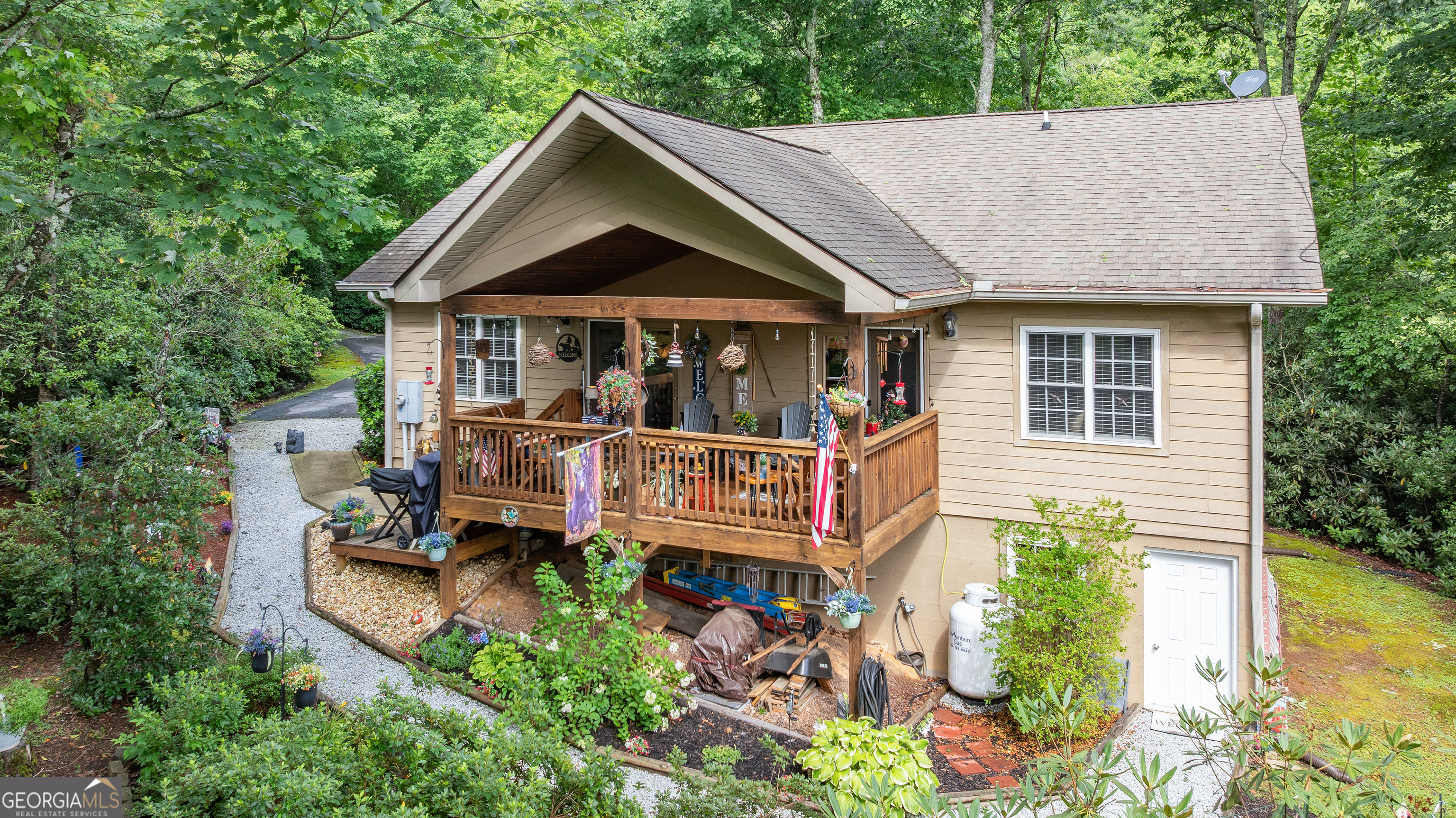 Tucked away in the peaceful woods of Rabun Gap, this charming 3 bedroom, 2 bathroom home offers the perfect blend of privacy, comfort, and natural beauty. From the moment you arrive, the covered front porch welcomes you with its mountain views and relaxing wooded surroundings, an ideal spot for morning coffee or evening unwinding. Step inside to find warm, wood-accented ceilings, new flooring, and a well-equipped kitchen with new stainless steel appliances, all set against the inviting character of a true mountain home. The home also features an incredible workshop space, perfect for projects, storage, or mountain hobbies. Surrounded by nature and lovingly kept, this property is ideal for those looking to slow down and enjoy the simplicity of mountain life - whether as a full-time home or peaceful getaway. Located in the heart of Rabun County, just a short drive to hiking, waterfalls, lakes, and charming small towns.
