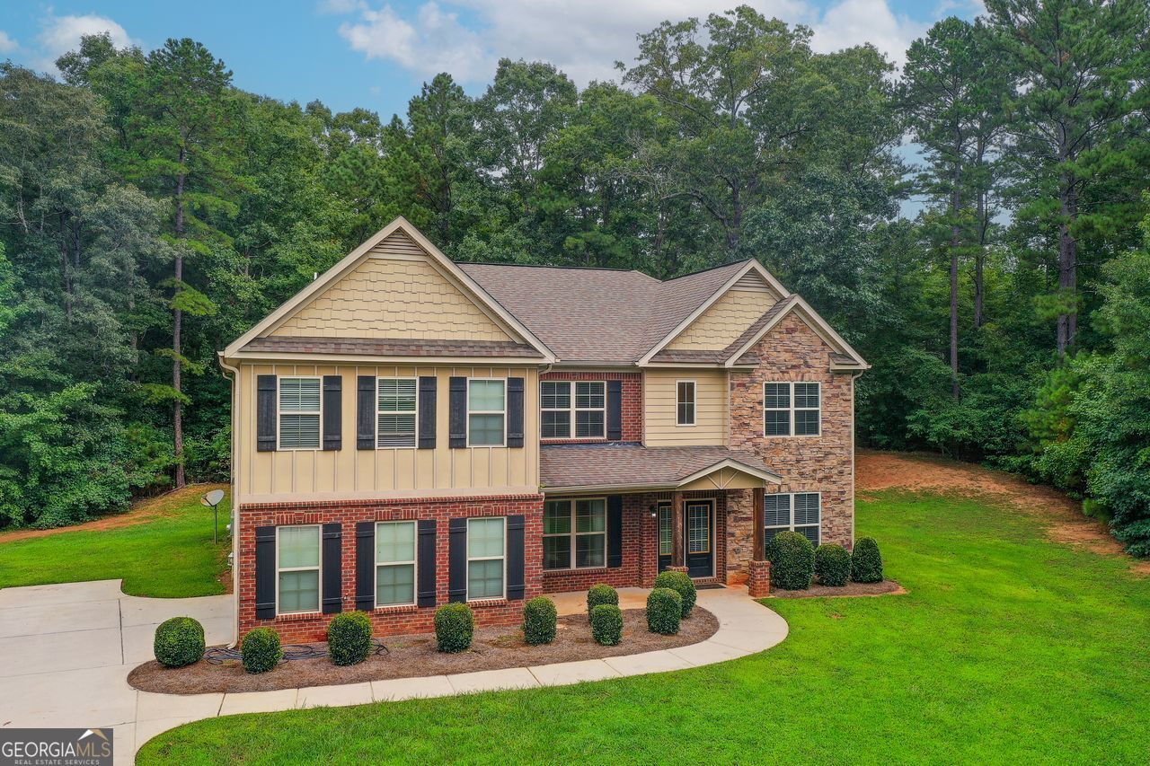 Welcome to this beautiful two-story home in the desirable Marie Farms community, where modern convenience meets timeless appeal. Nestled in a quiet cul-de-sac in Palmetto, this stunning 5-bedroom, 4-bath residence offers space, comfort, and thoughtful design throughout. A guest bedroom and full bath on the main level provide ideal accommodations for visitors or multi-generational living. The open-concept kitchen is a chef's dream-featuring an oversized island, granite countertops, double wall ovens, stained cabinets, stainless steel appliances, and plenty of room for cooking and entertaining. The adjoining family room centers around a striking stone fireplace, creating a warm and inviting atmosphere. Step outside to the covered patio-perfect for entertaining, quiet mornings, or relaxing evenings. Upstairs, you'll find a loft and four additional bedrooms, including the oversized primary suite with a walk-in closet, dual vanities, a separate tub, and a tiled shower. The laundry room is conveniently located on the upper level for added ease. With spacious living areas and a functional layout designed for today's lifestyle, this home is perfect for growing families or anyone who values space and comfort. Don't miss your chance to make this exceptional home your own!