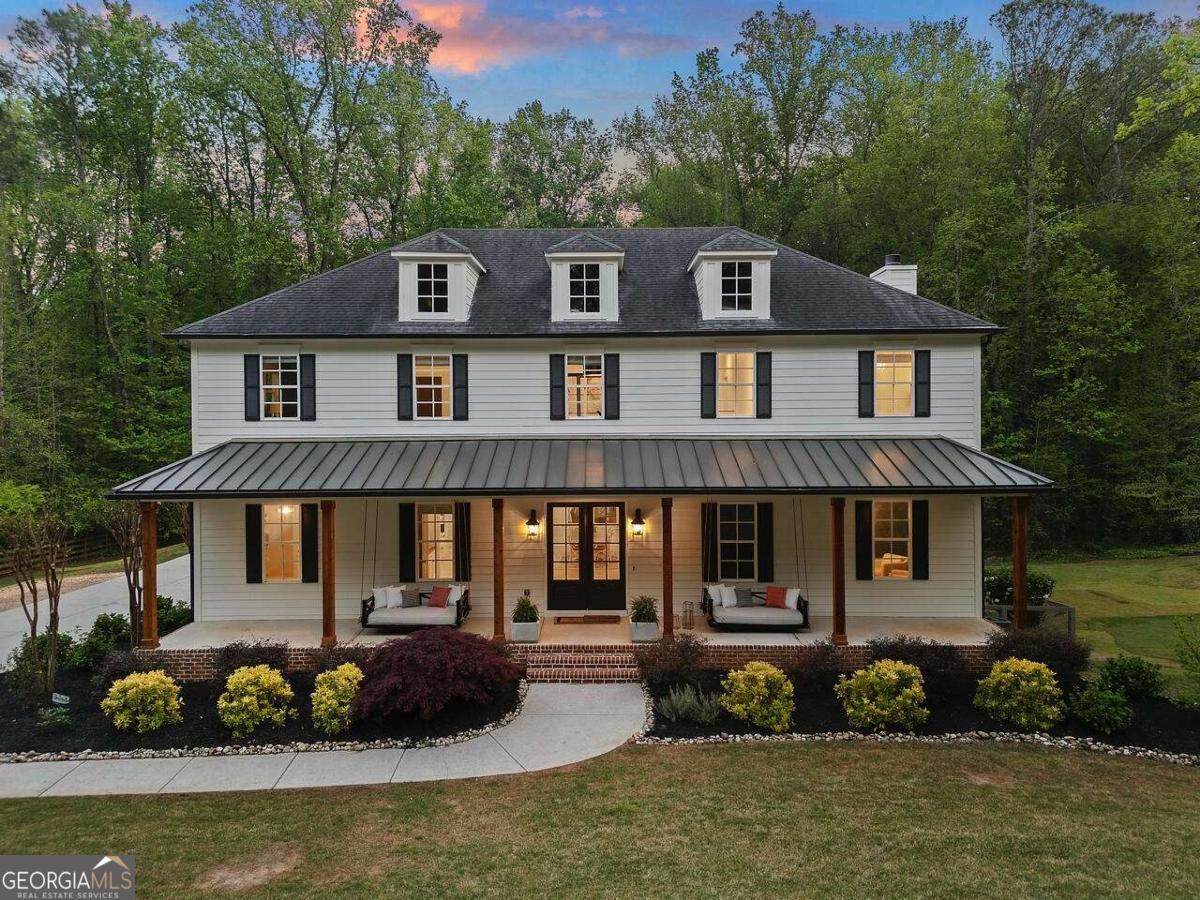 A newly remodeled Georgian-style property minutes from Historic Downtown Roswell! Priced BELOW appraised value, 650 Jones Road is a stunning showcase of modern elegance and spacious living. It is located in the heart of the desirable 30075 zip code and Roswell High School district, just minutes from Historic Downtown Roswell. Built in 2014, this 7,000 Sq Ft home features 7 bedrooms, 6 full, and 2 half baths, on a lush 1.66-acre lot. The heart of the home is its open floor plan, where a state-of-the-art kitchen equipped with high-end appliances and a generous island effortlessly transitions into a dining and family area, bathed in brilliant natural light streaming through oversized windows and stylish iron-framed glass doors. Ten-foot ceilings and sleek white oak flooring add to the sense of spaciousness. Step outside to relax, where a covered patio and pool oasis await, complete with a spa, waterfall, and cozy fire pit overlooking the meticulous landscaping and private backyard. The main level continues to impress with its sizeable guest suite and chic home office bordered by striking iron-framed glass barn doors. Below, the MUST-SEE terrace level is spectacularly finished, utilizing a nearly identical floor plan as the main level, making it perfect for hosting guests or extended family stays. The upper level is a remodeler's dream, framed using oversized manufactured trusses that allow any interior wall to be moved or reconfigured. The upper level is host to a luxurious master suite with a spa-inspired master bathroom, a vast walk-in closet with custom cabinetry, a convenient secondary laundry room, 4 additional bedrooms, 3 guest bathrooms, and an incredible home office with a floor-to-ceiling iron-framed glass entryway. This must-see home has been meticulously maintained and is move-in ready. It has award-winning schools and a fantastic location for everything Atlanta offers- it's the perfect place to call home.