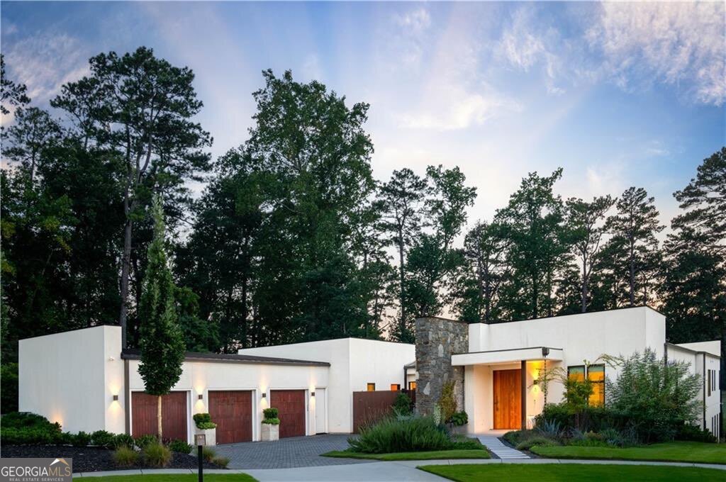 If there were levels of perfection for location, design, style , and utility, 1572 Clifton Ridge would be the perfection of the perfect. Literally a five minute walk to the Emory University campus , an epicenter of education and culture, this home is built of the finest materials available in the market. Paradise awaits a new owner with a truly unique and scarce combination of the best Atlanta has to offer. This pristine home is sited in a private cul-de-sac atop a crest overlooking Druid Hills golf course, on a lusciously landscaped lot enveloping this structure. Completed in 2023, this home has barely been lived in. It is still in "like new" condition. The clean, contemporary design provides order to every aspect of the environment . The quality of the materials used to craft this home is evident the moment you step into its welcoming , warm embrace. Served by a whole home "Smart" Lutron system, the security system, lights ,HVAC, audio visual system and automatic window shades can all be controlled by cell phone or by voice activation within the home. From the moment you enter the custom wooden door, natural light fills every inch of this stylish open floor plan, an environment that produces order and calm. The automatic sliding doors in the living room open the kitchen and dining room to a walk-out pool, an oasis with a firepit and views of the golf course that will take your breath away from sun up to sun down. The kitchen provides the highest quality appliances available in the market , featuring double Gagenau ovens and sleek , clean, convection cooktop. Separate and spacious refrigerator and freezer are disguised behind furniture quality wood work. A large scullery is hidden behind the wood panels, blending into a clean, sleek environment. A convenient yet private, window lined primary suite overlooks the pool and the golf course. The primary bathroom hosts an award-winning shower and stand-alone tub along with a closet fit for a clothes collector. On the other side of the U-shaped home there are three large bedrooms, all with en-suite , large, luxurious bathrooms and closets. On the main level, supporting a calm and convenient lifestyle, there is a media den with built in projector and audio visual system. An office at the front entry foyer provides a spacious yet private enclave for private productivity. A three car garage with EV charging station flows into a cabinet lined hallway, with a laundry room, pantry and powder room all with no steps into the entire main level. The terrace level has a very private full bedroom, bathroom and living area with its own private entrance . A recreation room for all the fun games along with a separate music room and gym with a sauna all provide the complete package for this incredible home.