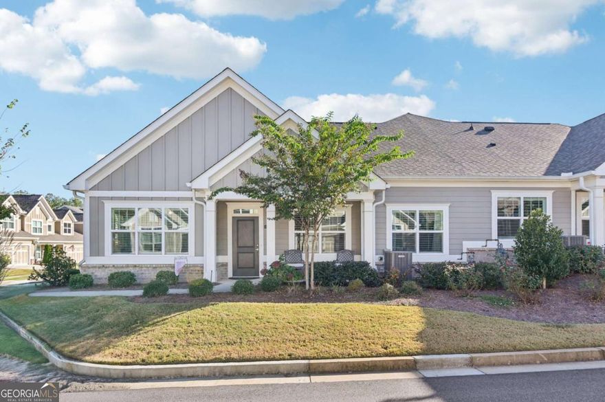 Like new home in the Orchards of Central Park - Active Adult Community Ranch! This beautifully maintained 2,380 sq ft home offers easy, single-level living with thoughtful upgrades throughout. Bright living room has built-ins and a cozy fireplace while formal dining is perfect for entertaining and flex living/office offers multiple possibilities. The main level features an owner's retreat with a spacious bedroom and spa-style bath with quartz countertops, step-less shower, bench seat, and glass enclosure. A second bedroom with full bath and walk-in closet is perfect for guests. Upstairs, a large loft/bedroom is currently set up as an entertainment space with a pool table, storage, spacious closet, and room to add a kitchenette. The open-concept kitchen with breakfast bar and new dishwasher flows into the family and dining rooms-ideal for entertaining. Wide plank hardwood floors and abundant natural light create a fresh, airy feel. Custom plantation shutters throughout. Enjoy the beautifully landscaped private corner lot from the inviting front porch. Community amenities include a 2-car garage, clubhouse with gathering and meeting rooms, fitness room, pool changing area, saltwater pool, and open green spaces. Fantastic location with easy access to GA 400, shopping, dining, medical facilities, and entertainment. Adjacent to Central Park with walking trails, tennis, and a recreation center. HOA covers exterior paint, roof replacement, and weekly lawn maintenance for low-maintenance living. Book your tour today!
