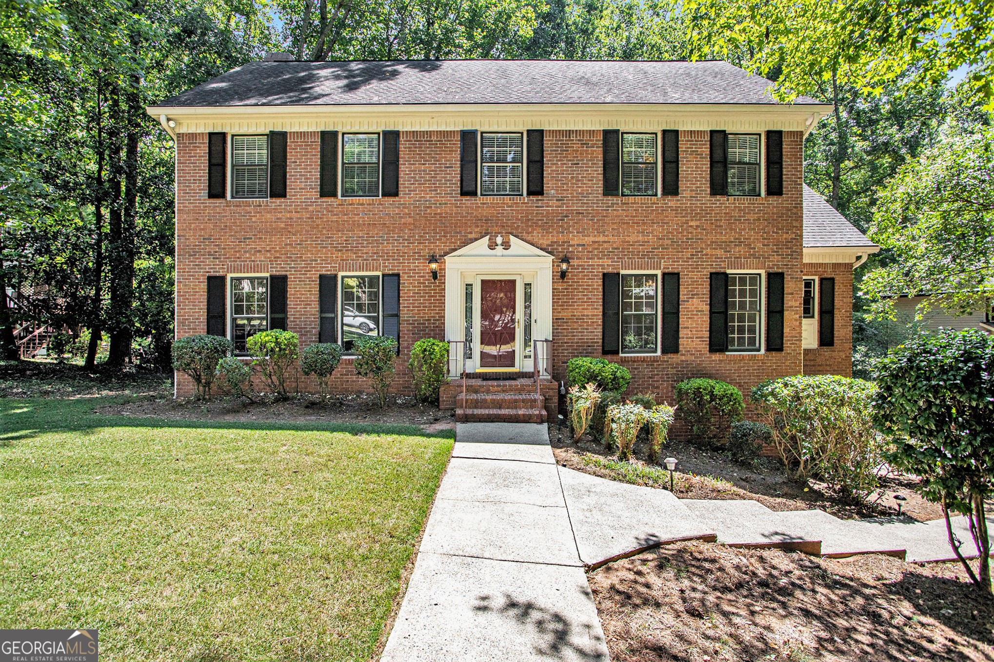 Bring your family home to this covetable traditional home situated inside the highly in demand subdivision of Charlton Forge in Marietta, GA. This home features a conventional floor plan. The main level boasts separate living and dining room areas, along with a spacious family room that features built in cabinetry and a fireplace. In the kitchen find granite countertops, an island with a cooktop stove, stainless steel appliances, a nice sized laundry room, a half bathroom and entertain year around with a huge deck right off the kitchen. As you make your way upstairs you come upon 4 generously sized bedrooms and 2 full bathrooms, the primary offers two closets, a laundry shot, with an ensuite bathroom, double vanities and skylight windows. Now make your way downstairs to a finished basement that includes an additional living space, 2 bonus rooms and a full bathroom right off a large 2 car garage. The property has a substantial backyard which is fenced, with a patio space for further entertaining. And can park up to 6+ more cars on the long paved driveway. This residence features new carpet (2024), a recently installed water heater and freshly painted walls throughout the main and second level. An entire new roof (2018), along with soffits and gutter replacements in 2023. Newer hardie plank siding on the back of the house (2023). The updated dual HVAC systems (2021/2023) and furnace ensure year-round comfort, while the property's prime location in a sought-after school district adds an extra layer of appeal. This community offers 2 tennis courts, pickleball and a pool. Located just minutes away from the Marietta Square shopping plaza where you can enjoy in a plethora of restaurants, shops and entertainment throughout the year, or take in the beauty of nature at Kennesaw's Mountain National Battlefield Park, with easy accessibility to I-75 and 285 and so much more.