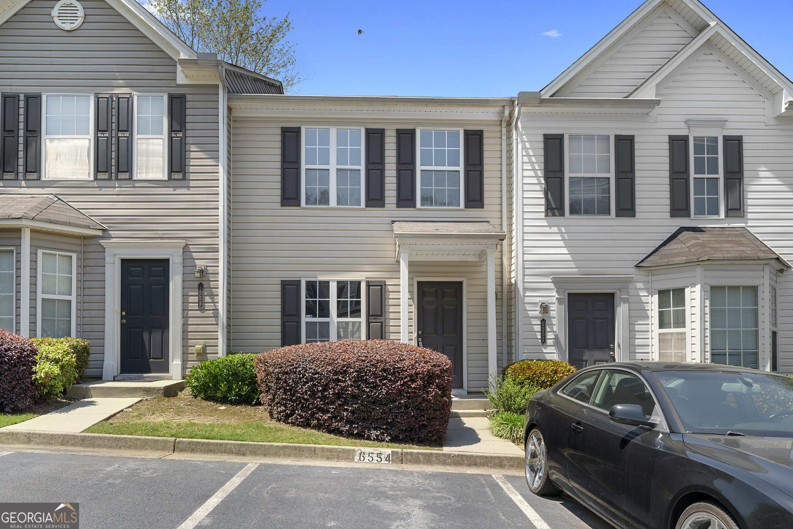 Come see this beautifully updated townhouse located in the gated Arbor Gate community. The main level offers an open-concept layout, seamlessly connecting the kitchen, dining, and living areas-perfect for both everyday living and entertaining. The kitchen features crisp white cabinetry, stone countertops, stainless steel appliances, and stylish black hardware for a modern touch. The spacious living room feels warm and inviting with a cozy fireplace as its centerpiece. Upstairs, you'll find two generously sized bedrooms, each with its own updated ensuite bathroom featuring new vanities. Fresh paint and new flooring throughout the home give it a clean, modern feel-ready for you to move right in.