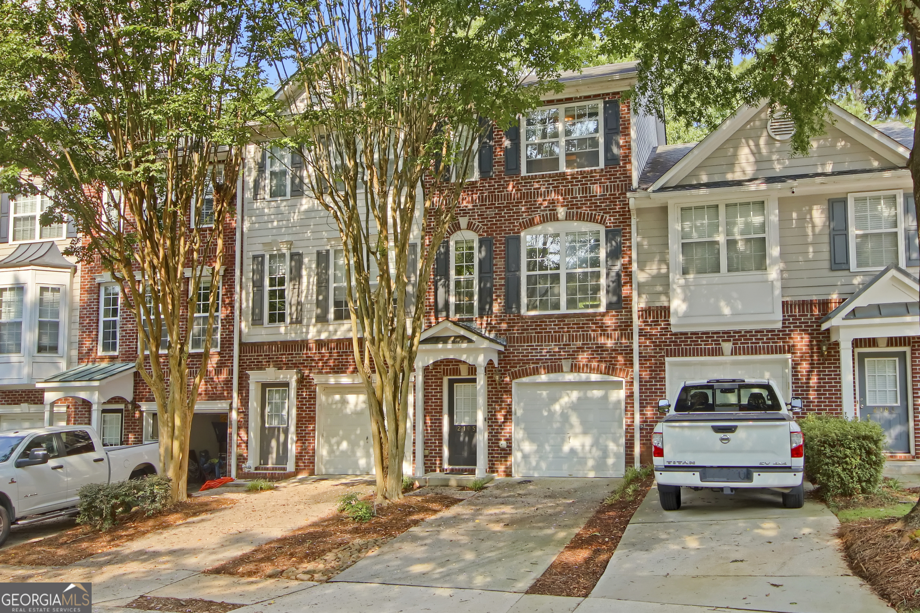 Welcome to this spacious tri-level townhome located in one of Tucker's most desirable communities. Located in a secluded gated community. This 2-bedroom, 2.5 bath home showcases beautiful hardwood floors throughout, adding warmth and elegance to every level. The versatile bonus room in the basement is perfect for a home office, media room, or entertaining space. The main level offers a bright family room with a cozy fireplace, breakfast area, and a breakfast bar overlooking the kitchen with stainless steel appliances. Enjoy outdoor living with a deck, patio, and private backyard. Home also includes a one-car garage. Community amenities include a swimming pool and HOA services, all within a quiet neighborhood close to shopping, dining, and major highways. Don't miss this opportunity to own a well-maintained home!