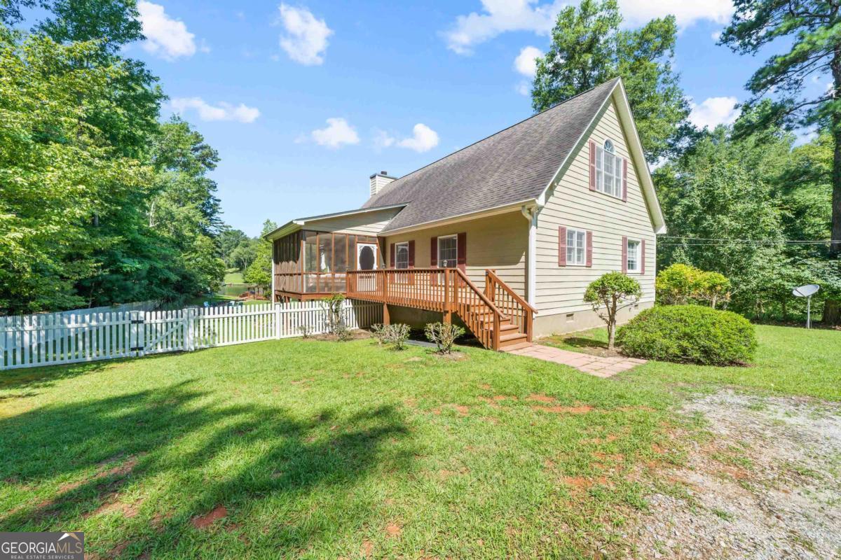 Adorable Lake Sinclair A-Frame with Upgrades & Outstanding Rental History! Don't miss this beautifully updated 3-bed, 3-bath lakefront home on a 1.56-acre lot with beautiful Lake Sinclair views! Recent improvements-new stainless-steel appliances, fresh interior paint, and an extended back deck-add style and functionality. Inside, the main level offers a bright, open living and kitchen area with vaulted tongue-and-groove pine ceilings and exposed beams. Hardwood floors and large windows flood the space with natural light, while French doors open to the expansive deck-perfect for morning coffee or sunset gatherings. The owner's suite features a generous bath and walk-in closet, accompanied by a second bedroom and full bath on the main floor. Upstairs, a loft-style bedroom with its own bath provides flexible space for guests, an office, or a media area. Outdoors, relax on the extended deck or head to the covered boat dock. The home comes fully furnished, making it effortless to move in or continue as a turnkey short-term rental with an impressive rental history. Schedule your private showing today and start living-or renting-the lake life! One year home warranty to Buyer at close!