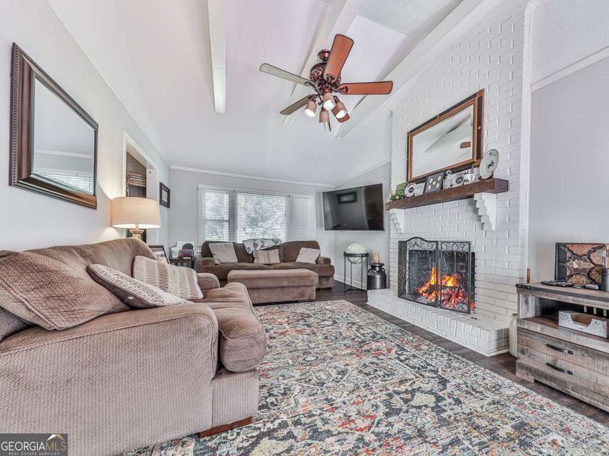 Charming Woodstock Home with In-Law Suite on Corner Lot in Little Brook Estates!  Welcome to 132 Little Brook Drive - a versatile and beautifully maintained 4-bedroom including in-law suite, 3-bathroom home nestled on a spacious corner lot in the desirable Little Brook Estates community. This thoughtfully designed residence offers comfort, functionality, and plenty of space for multi-generational living, guest accommodations or potential income. The main level features a desirable master suite on the main, along with two additional bedrooms and a full guest bath with a tub/shower combo and stylish ceramic tile flooring. The spacious eat-in kitchen with new stainless appliances opens to a cozy family room with fireplace, and French doors lead out to a wooden back deck complete with a grilling area and hot tub, all overlooking a peaceful, fenced backyard-perfect for relaxing or entertaining. Convenient stackable washer and dryer are located in the main level guest bath. Downstairs, enjoy a private in-law suite/studio with interior access, complete with its own kitchen, full bath with shower, full-size washer and dryer, and dedicated sleeping and seating areas. The suite also features a separate exterior entrance and driveway, ideal for added privacy or potential rental income. Outside, the very spacious fenced backyard includes a large workshop/storage shed and room for RV parking. Recent updates, along with new appliances, include new HVAC (June), newer roof with new gutters and gutter guards, and newer hot water heater-providing peace of mind for years to come. Located just minutes from Downtown Woodstock, shopping, dining, and easy access to I-575 & Express Lane, this home truly offers the perfect blend of comfort, flexibility, and location!