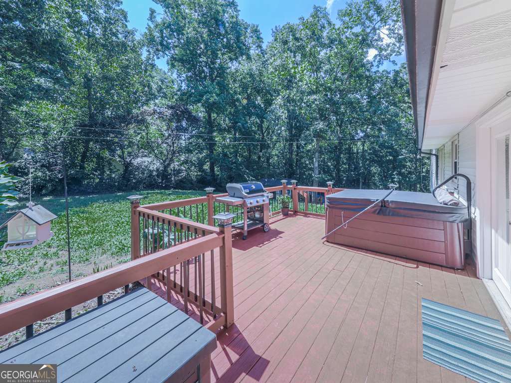 Charming Woodstock Home with In-Law Suite on Corner Lot in Little Brook Estates! Welcome to 132 Little Brook Drive - a versatile and beautifully maintained 4-bedroom including in-law suite, 3-bathroom home nestled on a spacious corner lot in the desirable Little Brook Estates community. This thoughtfully designed residence offers comfort, functionality, and plenty of space for multi-generational living or guest accommodations. The main level features a desirable master suite on the main, along with two additional bedrooms and a full guest bath with a tub/shower combo and stylish ceramic tile flooring. The spacious eat-in kitchen with new stainless appliances opens to a cozy family room with fireplace, and French doors lead out to a wooden back deck complete with a grilling area and hot tub, all overlooking a peaceful, fenced backyard-perfect for relaxing or entertaining. Convenient stackable washer and dryer are located in the main level guest bath. Downstairs, enjoy a private in-law suite/studio with interior access, complete with its own kitchen, full bath with shower, full-size washer and dryer, and dedicated sleeping and seating areas. The suite also features a separate exterior entrance and driveway, ideal for added privacy or potential rental income. Outside, the very spacious fenced backyard includes a large workshop/storage shed and room for RV parking. Recent updates, along with new appliances, include new HVAC (June), newer roof with new gutters and gutter guards, and newer hot water heater-providing peace of mind for years to come. Located just minutes from Dowtown Woodstock, shopping, dining, and easy access to I-575 & Express Lane, this home truly offers the perfect blend of comfort, flexibility, and location!