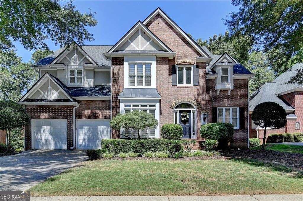 Gorgeous Golf Course Views & Private Retreat Step into this beautifully maintained home featuring a guest suite conveniently located on the main level. A dramatic wall of windows in the great room fills the space with natural light and frames serene views of the private backyard, where trees create a peaceful setting along the golf course. The expansive primary suite is a true retreat with a fireplace, tray ceilings, and a lovely bay window. The en suite bathroom delivers more "wow" moments with soaring vaulted ceilings, a private window above the soaking tub & separate vanities. The kitchen is light, bright, and functional with white cabinetry, stainless steel appliances, and extra storage space-including glass display cabinets, built-in wine storage. Hardwood floors span both the main and upper levels, adding timeless charm throughout the home. The great room flows seamlessly to an oversized deck, ideal for entertaining or relaxing in total privacy. Just off the entrance, a cozy office with custom arched built-ins provides the perfect workspace, while a separate flex room can be used as a formal dining room or bonus space. The unfinished basement ( 1,582 sf )offers walkout access, golf course views, and is already framed for future bedrooms and expansion-perfect for creating even more personalized living space down the road. Living in Windward means access to exceptional resort-style amenities including a private 195-acre lake for boating and fishing, a sports park, walking trails, and the optional Windward Lake Club and Golf Club of Georgia memberships. Just minutes from top-rated schools, Avalon, and GA 400, this home offers both luxury and lifestyle.