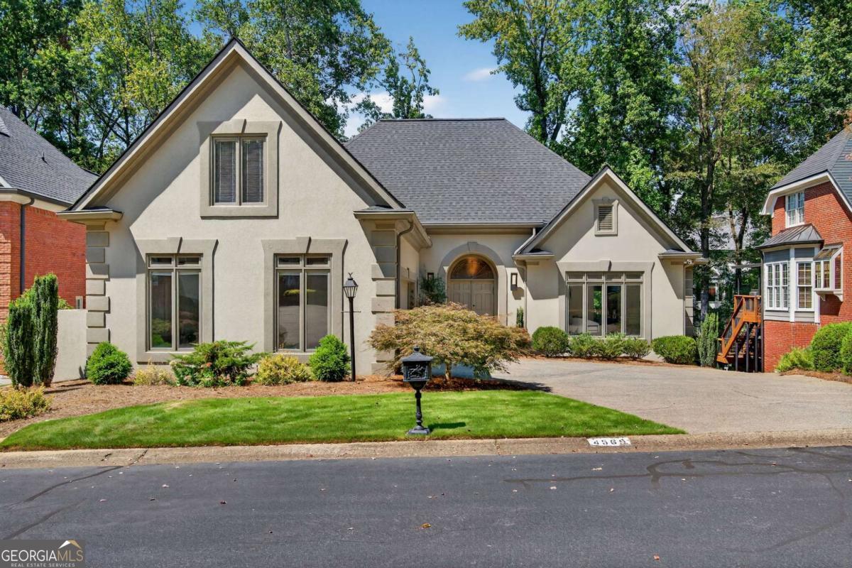 Offering 4.99% Owner Financing! Welcome to 4569 Fountain Dr., a beautifully renovated East Cobb home where modern elegance meets everyday comfort. This home has been thoughtfully updated with high-end finishes, a new roof, a tankless water heater, and curated lighting that is truly a work of art from one of Atlanta's most sought-after purveyors. At the heart of the home is a chef's kitchen that balances style and function with sleek Italian Gatto cabinetry and top-of-the-line Gaggenau appliances, including precision ovens, an innovative cooktop, and integrated refrigeration. Together, they create a space that is both visually stunning and highly practical-perfect for everyday living or entertaining. The main-level primary suite offers convenience and luxury, complemented by a main-level office. Upstairs, you'll find three spacious bedrooms and a loft with a built-in desk, ideal for homework or creative projects. The finished basement-with its own private entrance-features a bedroom, living room, game room, a spa-like bath with steam shower, and a second full kitchen, making it perfect for a private guest suite, live-in nanny, or running a home business. Outdoor living is just as impressive, with multiple covered and uncovered decks designed for hosting or relaxing in nature. And with the HOA handling front landscaping, daily life here is truly low-maintenance. Located within walking distance to the synagogue, this home offers not only style and comfort but also an ideal East Cobb location. 4569 Fountain Dr. is more than a house-it's a lifestyle of refined design, modern convenience, and easy living.
