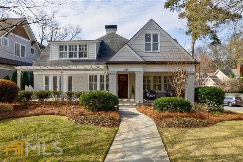 Beautiful corner lot cottage with guest house in Morningside. Completely updated with a finished terrace level, this STUNNING five bedroom home wants for nothing. The eat-in kitchen with Wolf & Sub-Zero appliances and marble countertops looks out over a cozy family room and breakfast room - both of which have French door access to the spacious screened in porch! You're welcomed inside the home by a formal living room adorned with crown molding, a gas log fireplace, 9 ft ceilings, and adjacent formal dining room and butler's pantry. The main floor goes on to host two ensuite bedrooms, an additional full bath, and a laundry room with chic built-in storage. Upstairs you'll find two additional en-suite bedrooms including the primary suite with an updated and elegant bath (marble shower, heated marble flooring, separate soaking tub and separate walk-in closets being just some of the special features this space offers). The second ensuite is spacious with high ceilings, great natural light, and exposed brick detailing. The finished terrace level's bonus room is the perfect space to host a game-day viewing party and also has an in-home work out space, kitchenette, and access to the carport. From the screened-in porch you walk out to a lovely turfed, fenced-in backyard and patio/fire-pit. From the backyard one can access the beautifully finished, studio guest house which acts as the home's fifth and sixth bed/bath. The home provides additional outdoor living space via the front porch (equipped with oversized porch swing, naturally) which overlooks a landscaped, flat, a grassy front yard. Walking distance from schools, Morningside's and Virginia Highland's shops and restaurants, and central to Piedmont Park and The BeltLine, this homes offers the very best of luxury InTown living.
