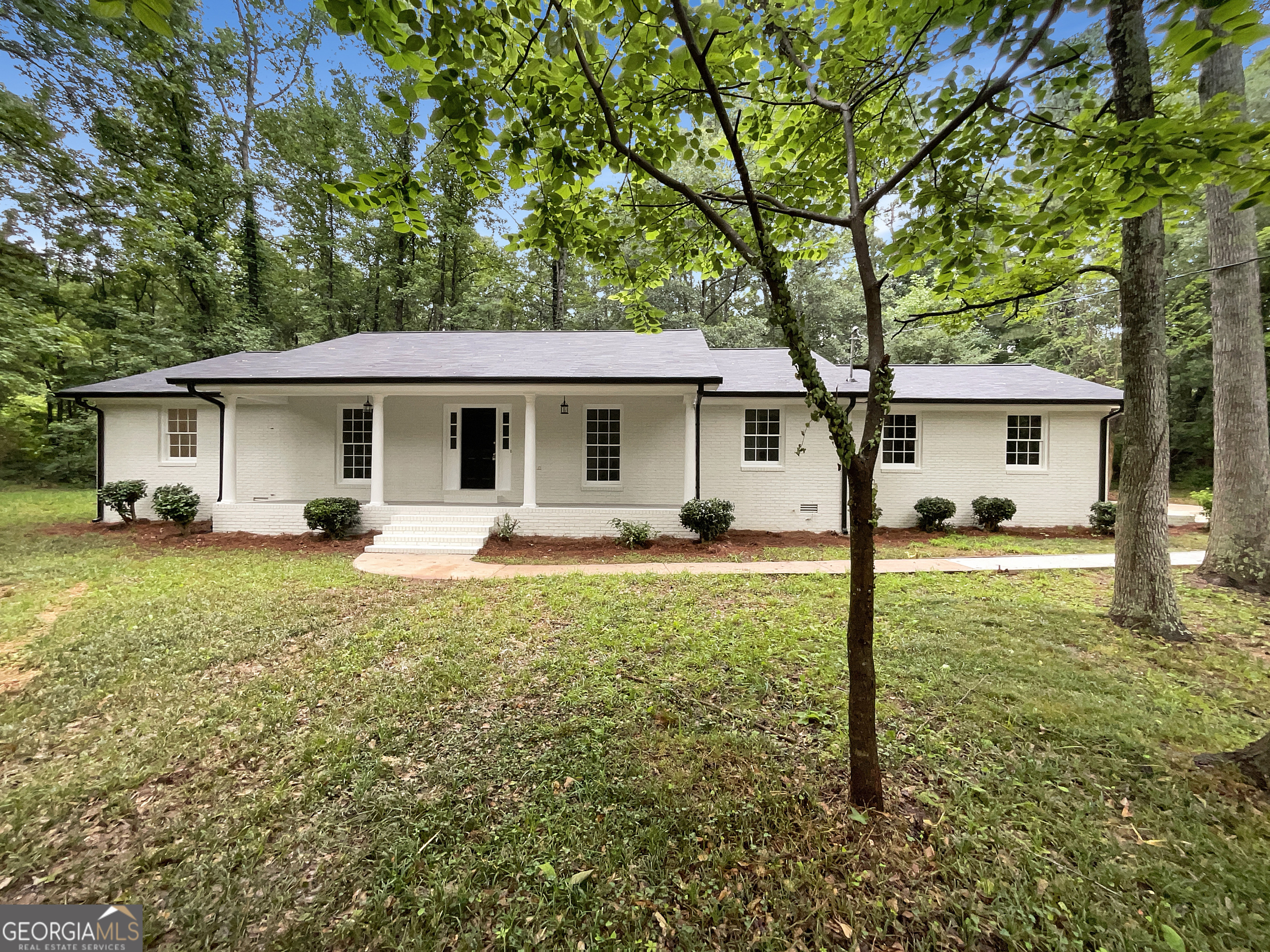Welcome to 185 Danbury Ct - a beautifully renovated 4-sided brick ranch nestled on a serene cul-de-sac lot just under an acre in the heart of Athens. This 3-bedroom, 2-bathroom home blends timeless charm with thoughtful updates and a location that offers the best of both privacy and convenience. Step onto the inviting covered front porch, perfect for a morning cup of coffee or evening relaxation, and into a spacious, light-filled interior. The vaulted family room features a cozy fireplace and opens seamlessly to the formal dining room, creating an easy flow for everyday living or entertaining. The showstopper kitchen has been updated and reimagined with a large center island with built-in cooktop, sleek granite countertops, stainless steel appliances, and white cabinets. Whether you're hosting friends or preparing weeknight meals, this kitchen offers both style and functionality. The primary suite is a peaceful retreat with a walk-in closet and a private bath featuring dual vanities for added convenience. Two additional bedrooms provide flexibility for guests, a home office, or family members, and share a well- appointed full bath. One of the standout features of this home is the spacious sunroom, filled with natural light and overlooking the expansive backyard - a perfect space for relaxing, entertaining, or even a hobby room or second living area. Enjoy recent updates including a new roof, new luxury flooring, fresh interior and exterior paint, and more - offering move-in peace of mind. Outside, the nearly 1-acre level lot provides endless potential for gardening, recreation, or future expansion. There's plenty of room to enjoy outdoor living, host gatherings, or simply unwind in your own private retreat. All of this is located just minutes from the University of Georgia, downtown Athens, top-rated schools, shopping, dining, and major roadways - making this home ideal for families, professionals, or those seeking comfort and convenience in a well-established neighborhood.
