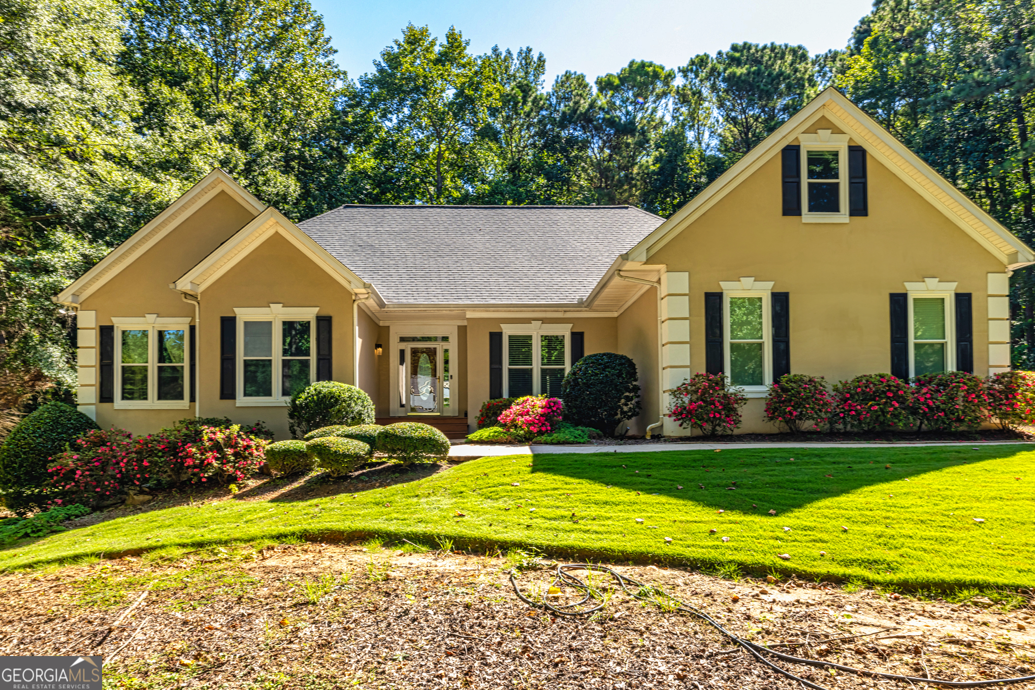 Welcome to this spacious and well-maintained Ranch home full of warmth, charm, and functional space, nestled in the desirable Springwater Plantation Windermere subdivision. Step inside to a light-filled main level featuring 3 bedrooms and 2 full baths, including a spacious owner's suite with walk-in closet, double vanities, walk-in Jacuzzi tub, and separate shower. The main floor also features a spacious great room with a cozy gas log fireplace, and a formal dining room perfect for gatherings. The large kitchen, which overlooks the private backyard, is equipped with stainless steel appliances, granite countertops, pantry, gas stove, and breakfast area. Just off the kitchen, a versatile office/den leads to a peaceful back deck overlooking the private backyard oasis. This outdoor space is built for relaxation and fun, complete with a sparkling in-ground pool with a new liner, pump, and filtration system, perfect for summer entertaining or quiet evenings under the stars. Upstairs you'll find a large bonus room, an additional office/flex space, full bath, and walk-in attic storage. The finished basement expands your living space with a large rec room, full bath, kitchen area, and storage space, ideal for entertaining or multi-generational living. Recent upgrades include: New roof (2022), New HVAC system (2023), 50-gallon water heater, Whole-house generator, Fresh interior paint. Community amenities include lake access, gazebo, and two playgrounds. Conveniently located just minutes from I-85 (Exit 51), Newnan, Peachtree City, and Northgate High School. This home offers the perfect balance of indoor comfort and outdoor entertainment. Schedule your private showing today and experience the charm and convenience this beautiful property has to offer!