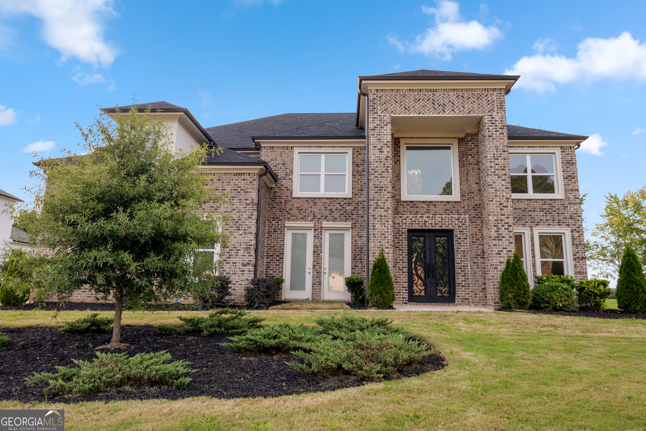 Welcome to Dogwood Manor Estates-Lithonia's most exclusive gated community! This Modern Transitional Masterpiece offers 5-bedrooms, 4-bathrooms, slightly under 4,000 sq ft of luxurious living space on the largest corner lot in the subdivision (0.4 acres) - unmatched privacy and presence. Built in 2023, this home blends modern elegance with everyday comfort. The open-concept layout is designed for both grand entertaining and immaculate living. High ceilings, expansive windows, and upscale finishes throughout.
