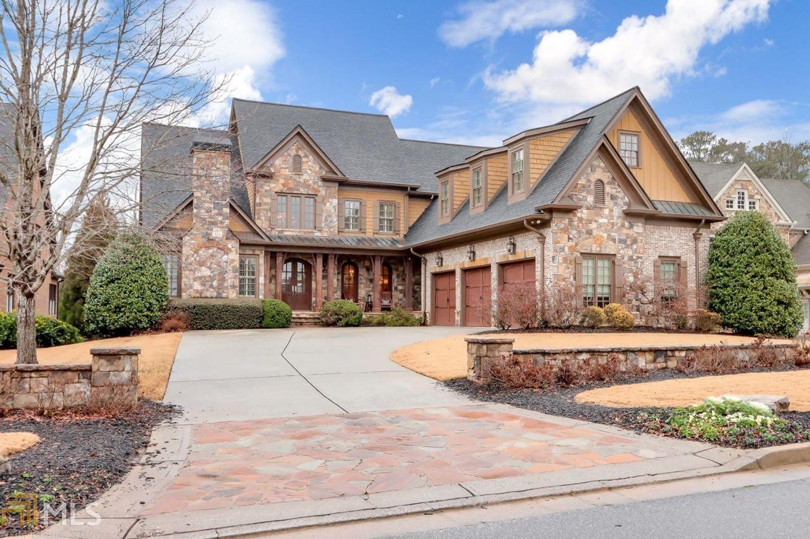 Stunning custom executive home in Walton! Hardwood floors - full of natural light.  Beautiful master on main with vaulted ceiling & private sitting room or office with fireplace.  Master bath features coffee bar, separate vanities, shower, tub & 2 toilets!   2 story foyer, dining room, great room, stunning white chef's kitchen with spacious island open to keeping room with stacked stone fireplace.  Office off kitchen.  3 bedrooms upstairs with walk in closets and baths.  Plantation shutters.All baths fully updated, new carpet & paint throughout.  3 year old roof.Terrace level finished to perfection with custom bar made for the space, stone arch entering private theater. Spacious bedroom, full bath and family room.  Walk out to your own private resort out back with stunning salt water, heated pool. Waterfall, hot tub, and waterslide - all controlled by an app on your phone!  Gorgeous deck.  House complete with the Sonos system to control speakers. Perfection - beautiful finishes and moldings.