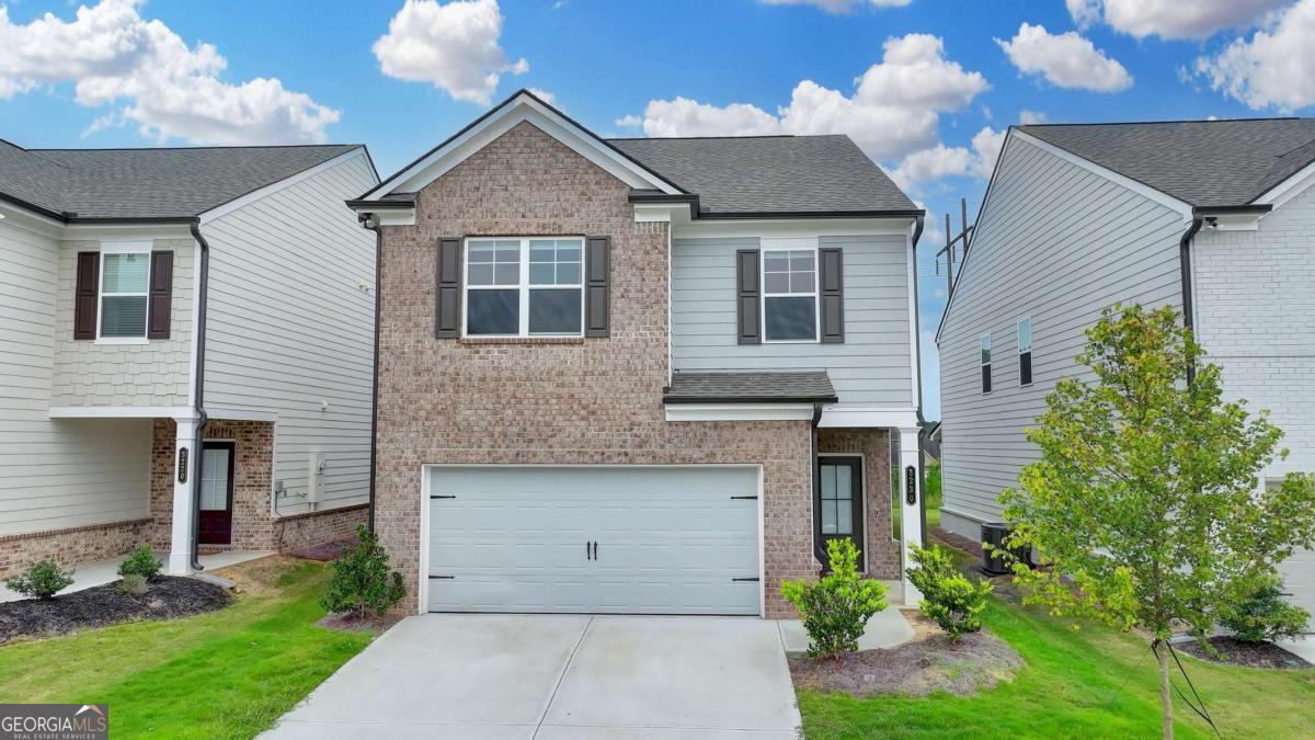 Welcome to this beautiful home in the highly sought-after Westgate community, zoned for award-winning Grayson High School! This stunning 3-bedroom, 2.5-bath brick-front residence is just 2 years old and showcases a bright, open-concept floor plan. The inviting foyer leads into a spacious great room that seamlessly connects to the kitchen and dining area-perfect for both everyday living and entertaining. The chef's kitchen boasts a center work island with barstool seating, large pantry, and generous counter space. A convenient powder room is tucked away on the main level, while gleaming LVP flooring flows throughout. Upstairs, you'll find a versatile loft area ideal for a home office, playroom, or additional lounge space. The level also features three comfortable bedrooms, two full baths, and a dedicated laundry room. The owner's suite is a private retreat with a spacious closet and a spa-inspired bath. Step outside to enjoy covered back porches and a fully fenced, level backyard-perfect for hosting gatherings or simply unwinding in your own outdoor oasis. Additional highlights include upgraded plumbing fixtures and a smart home package with doorbell, lock, security system, and smart light switches. Ideally located just minutes from top-rated schools, dining, shopping, downtown Loganville events, Grayson Railyard, and the scenic Vines Botanical Gardens, this move-in-ready home combines style, comfort, and convenience. Schedule your private tour today!