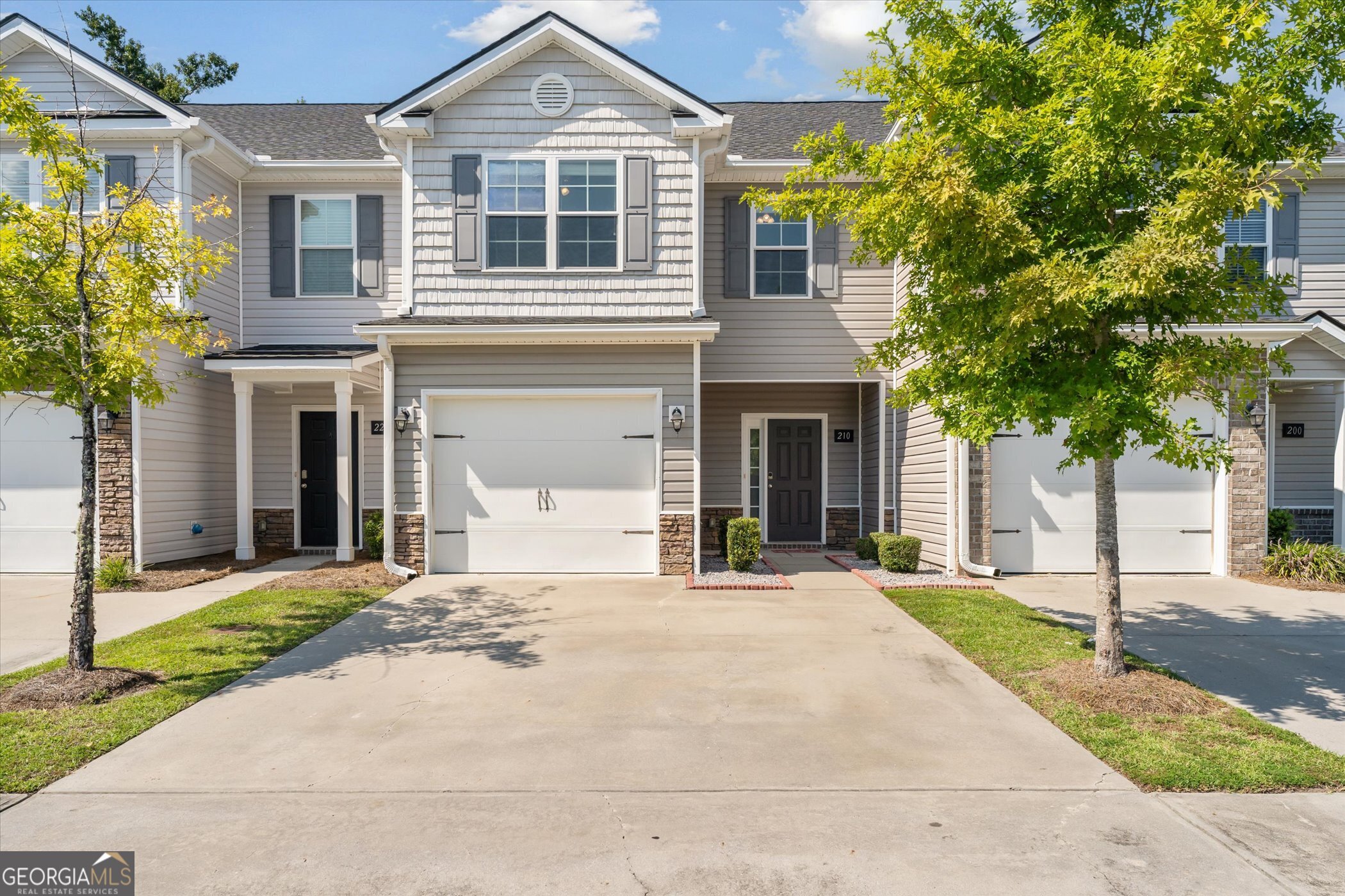 This 3 bedroom, 2.5 bath townhome has been thoughtfully updated and is ready for its next owner. Recent improvements include new LVP flooring, fresh paint throughout, new roof, serviced HVAC, and a replaced privacy fence. Carpets have been professionally cleaned and the water heater serviced. The kitchen features granite countertops and a pantry, opening to a bright living area with access to a private patio and fenced backyard with wooded views. Upstairs, the primary suite offers a tray ceiling, dual vanities, and walk-in closet, with two additional bedrooms and laundry nearby. An attached 1-car garage with automatic opener adds convenience. Newly completed city roadway and sidewalks enhance accessibility and curb appeal. Located close to Hwy 17 and I-95 for quick commutes to Savannah, Ft. Stewart, and Pooler.