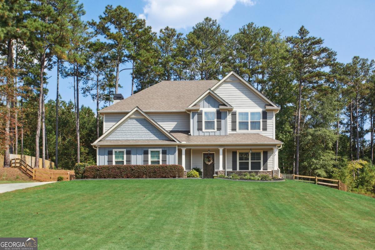 Stunningly updated and move-in ready! This nearly new home features engineered hardwoods throughout. Enjoy hosting family and friends in your designer kitchen, complete with top-of-the-line appliances, double pantries featuring custom shelving, and a spacious entertainer's island. Relax on the screened porch with stone fireplace or enjoy the covered outdoor patio, both with TVs-perfect for game day! Inside, the fireside family room and elegant dining room with coffered ceilings set the stage for gatherings. The luxurious primary suite offers dual closets, soaking tub, and tiled shower. Secondary bedrooms boast tall ceilings and generous storage. Additional highlights include a temperature-controlled garage with mini-split system, perfect for a workshop, craft space, or storage. Enjoy a large flat fenced yard ideal for children and pets, complete with a storage shed. Key features to note: Spray foam insulation, New HVAC system (2022), New hot water heater, fresh paint throughout, upgraded designer lighting, custom closets, and more. Tucked on a quiet street with extra HOA parking and a covered cabana perfect for hosting parties right across the street. Easy access to I-20, top schools, and all the dining, shopping, and parks of Carrollton and Villa Rica. This home truly has it all!