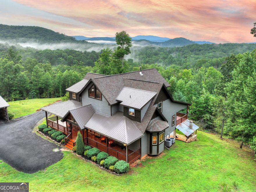 Privately tucked away on over 27 pristine acres, this custom-built 5 bedroom, 5.5 bath chalet captures breathtaking long-range views of the Blue Ridge Mountains. Surrounded by nature and bordered by USFS land, the property offers unmatched privacy with a serene creek meandering through. Designed for both comfort and style, the home features a soaring great room with a wall of windows to frame the mountain vistas, a floor-to-ceiling wood burning stove, and a spacious loft. Each bedroom is en-suite, providing luxurious privacy for family and guests. The gourmet kitchen boasts custom cabinetry, premium finishes, and an open flow perfect for entertaining. After a day outdoors, unwind in the indoor sauna, gather at the outdoor stone fire-pit under the stars, or fire up the built-in BBQ for mountain-side dining. A large barn/workshop offers endless possibilities for hobbies, storage, or equipment. With a mix of rolling pasture, hardwood forest, and creek frontage, the land is ideal for exploring, recreation, or simply enjoying the peaceful surroundings. A rare opportunity to own a true mountain retreat crafted by the builder for himself and his family with uncompromising space, privacy, and custom craftsmanship-just minutes from all the beauty and adventure the Blue Ridge area has to offer.