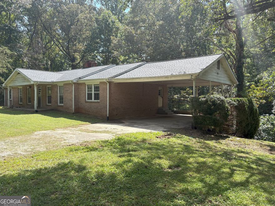Opportunity knocks in Dawsonville! This 3-bed, 2-bath ranch sits on 1.43 acres with a brand-new roof and endless potential. Spacious layout includes a partially finished basement, walk-in closets, and a cozy fireplace. Home needs renovation-perfect for investors, flippers, or buyers ready to customize. No HOA, private lot, and just minutes from GA-400. Bring your vision and make this property shine!
