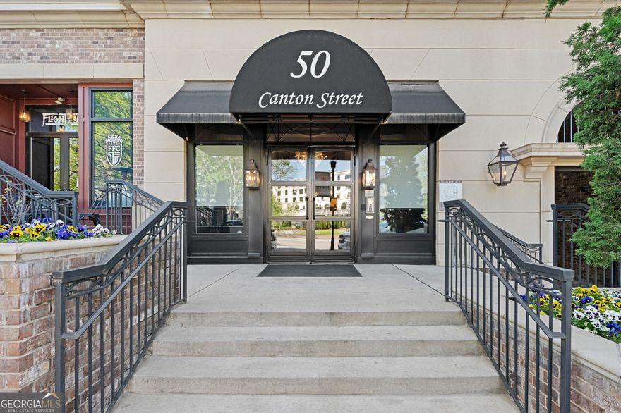 Experience the best of luxury living in this beautiful, fully furnished, one level living condo in downtown Alpharetta!  Enjoy the perfect blend of convenience and elegance with top amenities and prime location for shopping, dining and entertainment. This beautiful top floor unit features top of the line Wolf Cooktop and Sub-Zero refrigerator. The spacious open concept floor plan boast with high end finishes, elegant primary suite with spa like bath and walk in closet, private balcony with built in grill and fireplace overlooking Canton Street.  The added extras include concierge service for ultimate convenience, a beautiful landscaped courtyard, outdoor pavilion with kitchen and fireplace, a serene fountain, relaxing seating areas, fire-pit, cornhole or bocce ball area, dog park and fully equipped gym.  This unit comes with 2 parking spaces in the gated garage equipped with private charging stations to both spaces. Live in the heart of Alpharetta with easy access to Avalon, parks and more!  The best of luxury living in downtown Alpharetta!