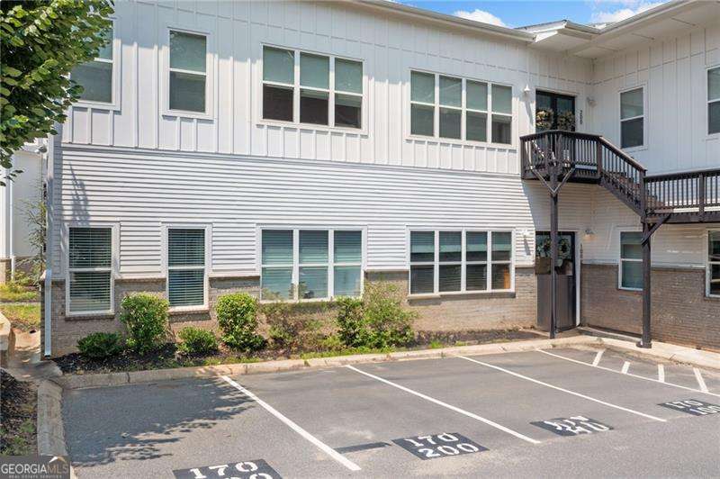 Charming Condominium in the Heart of Downtown Woodstock Nestled in the vibrant heart of Downtown Woodstock, this exquisite condominium offers the perfect blend of modern comfort and city living. Situated on the first level, this home features a spacious, open-concept floorplan with soaring 12' ceilings, allowing natural light to flood the space. As you step inside, you'll be welcomed by a beautiful courtyard, offering a peaceful escape in the midst of it all. The gourmet kitchen is a standout, complete with stainless steel appliances, an oversized island perfect for entertaining, and elegant granite countertops. The open design flows seamlessly into the living and dining areas, creating a welcoming space for family and friends. Throughout the home, you'll find recessed can lighting, adding a sleek, contemporary touch. The master suite is conveniently located on the main level for ultimate convenience and privacy. Both bathrooms are tastefully tiled, providing a stylish and low-maintenance appeal. Step outside your front door, and you're immediately immersed in the lively downtown atmosphere. Explore an array of nearby restaurants, boutique shops, and the bustling farmers market. Don't miss the amphitheater, where you can enjoy concerts and local events year-round. With the entire living space on one level, this condominium offers the perfect mix of luxury and practicality in one of Woodstock's most desirable locations.