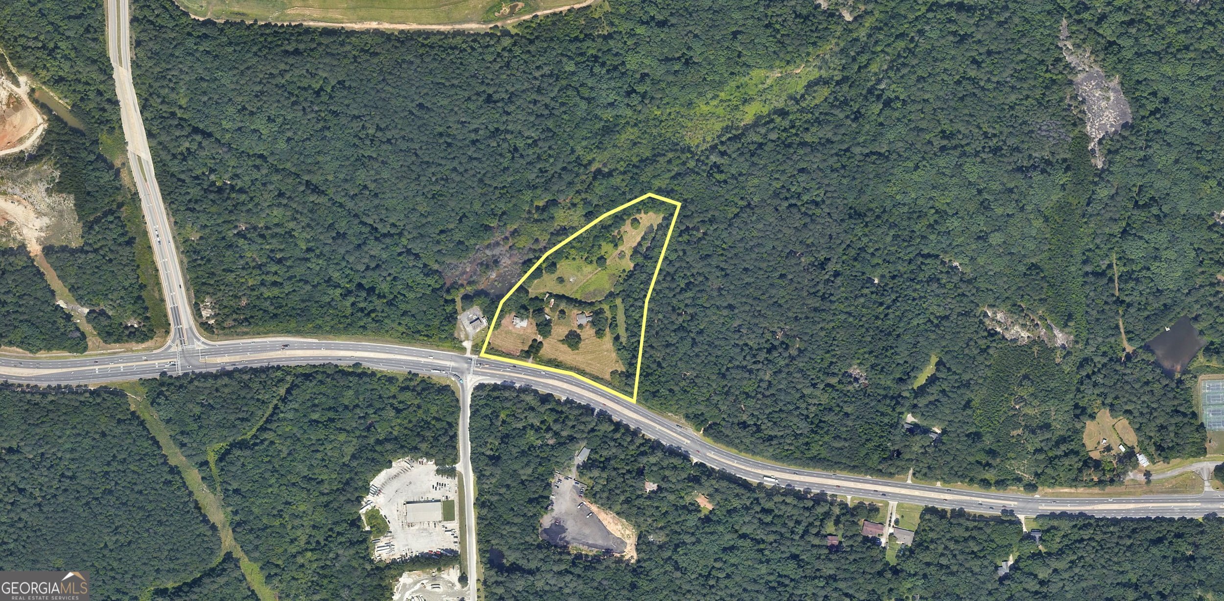 This property offers a rare combination of privacy, acreage, and proximity to major roads. Whether your vision includes a home-based business, a personal workshop, a hobby farm, or simply room to enjoy the outdoors, 1451 & 1473 Rock Chapel Road provide endless possibilities. - **Expansive 9.9 Acres**: Enjoy plenty of room for gardening, recreation, and expansion. - **Private Wooded Areas**: Perfect for walking trails, enjoying nature, and outdoor activities including bowhunting (per local regulations). - **Ideal for Many Uses**: - Suitable for hobby farming - bring your chickens or start your dream garden. - Great for those who need additional space for work equipment, projects, or storage. - Ample space and privacy for those seeking a spacious homesite or potential multi-use property. - **Home on Property**: Includes a 3-bedroom, 2-bath, 1,943 sq ft single-story home ready for full renovation or redevelopment. - **Currently Zoned R-100 and part of the SUB Land Use Plan - 8 Dwelling Units per Acre - **Convenient Location**: Quick access to Rock Chapel Road and less than 10 minutes to Interstate 20. Seller financing is available for qualified buyers. Material Relationship Disclosure: Listing Licensee is the Owner. Please see GMLS listing #10572583 for adjoining parcel that is included in the sale