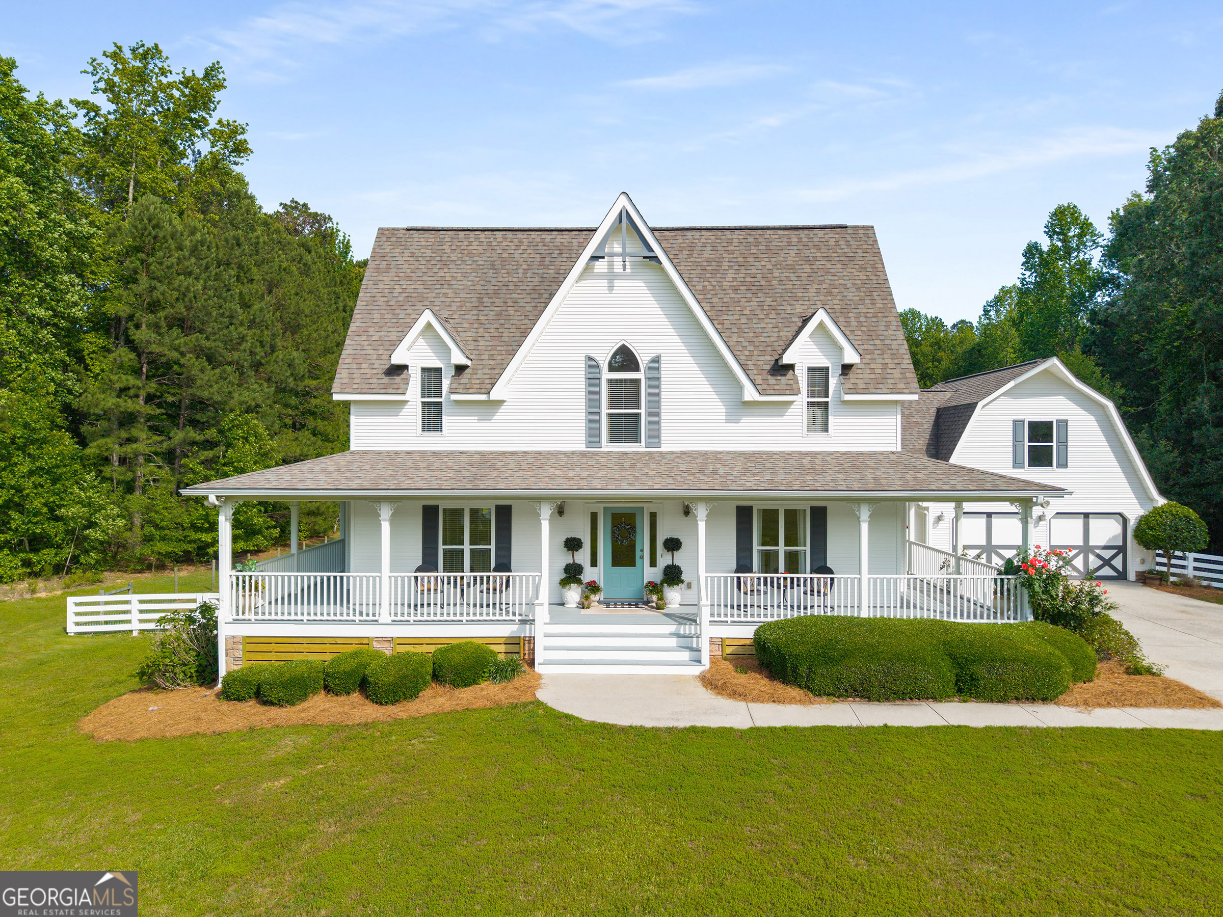 Country living meets historic charm in this Gothic Revival farmhouse on 5 acres in the heart of Brooks. Custom built by local builder Jeff Betsill, this home abounds with curb appeal through its distinctive architectural details to include arched windows, period-style corbels, and wraparound porches. Inside, the interior is equally as impressive with its banquet-sized dining room, chef's kitchen, and fireside family room all featuring ample natural light and Australian cypress hardwood floors. A private home office and primary suite on main comprise the home's main level. Upstairs, four bedrooms, all featuring hardwood floors and walk-in closets, along with two bathrooms await. The opportunity to expand is endless with the home's two, unfinished areas to include a full basement and in-law suite over the garage. Meticulously maintained by the current owners, enjoy the convenience of newer systems and cosmetic updates throughout: CertainTeed Roof (2017), 3 Trane HVAC systems (2017-2021), 2 water heaters (2023), fresh interior paint and lighting (2024). The flat, rear yard is fully fenced in and perfect for a pool. Offering quality construction, distinctive finishes, and a prime location within the award-winning Whitewater school district, this home is nothing short of special and an opportunity not to be missed.
