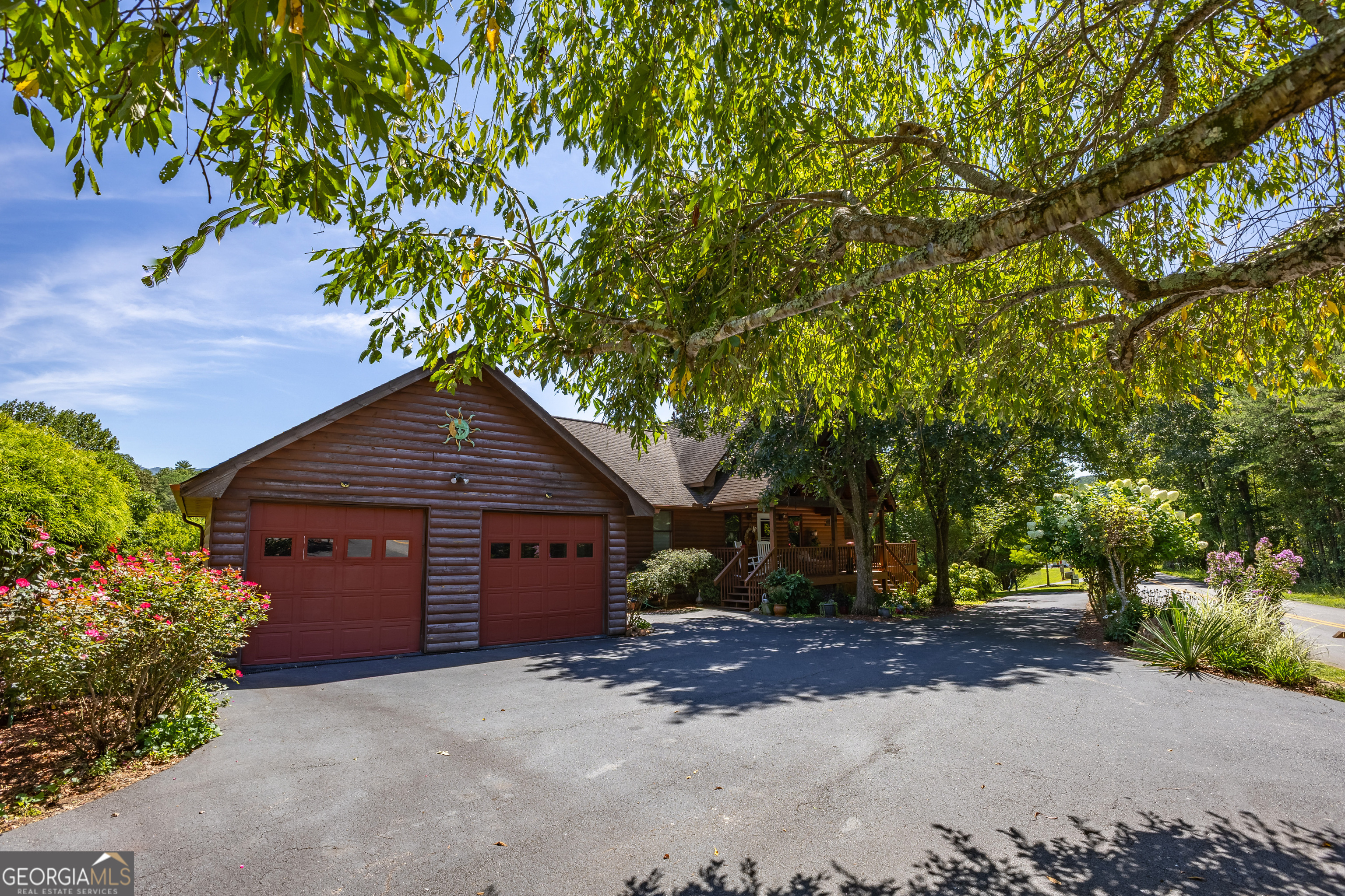This Blairsville cabin has it all! Enjoy a wraparound porch with stunning mountain views, a small creek running along the backyard property line, unlimited storage, a separate garage, a garage and storage room downstairs, plus an impressive 28x50 shop with lean-to, electricity, and water. The fully finished basement offers its own 1 bedroom, 1 bathroom, and kitchen, perfect for guests, in-laws, or rental potential. Tucked away on Big Sky Road, this property gives you the best of both privacy and convenience-just 6 minutes to Vogel State Park, 12 minutes to downtown Blairsville, and only 30 minutes to Helen, GA. Whether you're looking for a mountain retreat, multi-generational living, or a place with serious storage and workshop space, this cabin delivers it all.