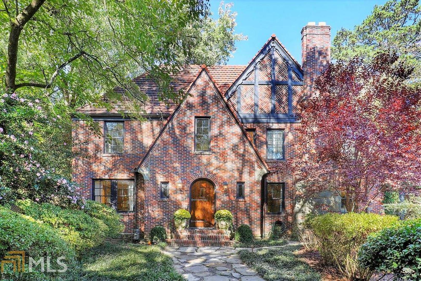 This enchanting Tudor home is sure to please.  Built in 1930, and masterfully renovated in the early 2000's under the supervision of Norman Askins.  Walk up the stone walkway and see the intricately carved gables and meticulously placed pattern-laid brick insets on the front facade of this home.  An original crystal flush mount light "greets you" at the entrance foyer.   The living room is adorned with its original mantle and marble apron restored during the Norman Askins project.  A master bath gracefully finished with an eye toward historic charm includes radiant heated flooring and a frameless steam shower.  See the newly painted white kitchen with its freshly restored antique French floor tiling and heart pine island.  Soap stones counters, and an absolutely charming breakfast dining area complete this one-of-a kind kitchen.  A really large attic makes for great "creative space" for you to tailor as you see fit.  Gorgeous grounds surround this Morningside treasure.  History sings its praises in the trees, the foliage, and the fountain that adorn this property.  Also on the grounds a detached two-car garage with a bonus room that works great for a workout or home-schooling space, and a charming "doll house style" shed that makes a perfect place for a workshop or hobby room.  This home sits in Morningside Elementary School district as well, highly rated and very desirable.