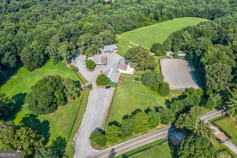 Chukkar Farm encompasses 67 +/- acres in the heart of the Sweet Spot of Cherokee. Own a piece of history and take over the reins to this spectacular farm with endless options for end-use. Polo Field 360' x 750', arena 80' x 120', three homes, barns, sheds, venues, and open-air barns are included in this assemblage of properties.  Little River runs through the rear of the property, highlighting abundant wildlife, fertile pastures, and trails for riding and hiking-an incredible location with Alpharetta address ~Cherokee County taxes. Additional properties included in the assemblage~ are 1399 Liberty Grove Road and 1140 Liberty Grove Road. THE SELLER WILL NOT SUBDIVIDE. The property is in a Cuva until December 31, 2027, which yields a low tax basis. 1375 Liberty Grove Road~ 02N10 106, 1399 Liberty Grove Road~ 02N10106B, 1140 Liberty Grove Road~02N10 077. Appointment only. Please do not drive onto the property without an appointment. Thank you.  GPS 1140 LIBERTY GROVE ~ This will take you to the main barn/polo field.