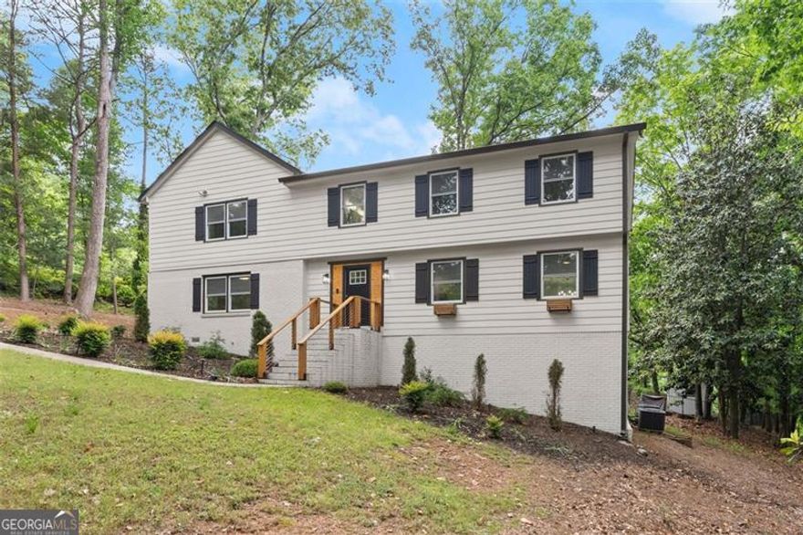 Located in beautiful Kings Mountain Neighborhood, within Marietta City limits. CUL-DE-SAC, and NO HOA here! Just a few miles from downtown Marietta Square. SELLER OFFERING $5K INCENTIVE TOWARDS CLOSING COSTS! This updated and well-maintained home comes with a crystal clear pool and multiple decks for all the pool parties you will host! The lot is wooded and private. The main level features 2 living/sitting areas, and a guest bdrm/office. The kitchen is bright and updated with white kitchen cabinets, quartz countertops, and bar seating. Hardwoods on the main level. Primary suite is a show stopper with vaulted ceiling, beams and its own deck. His/her's primary close.  All new paint throughout the house.