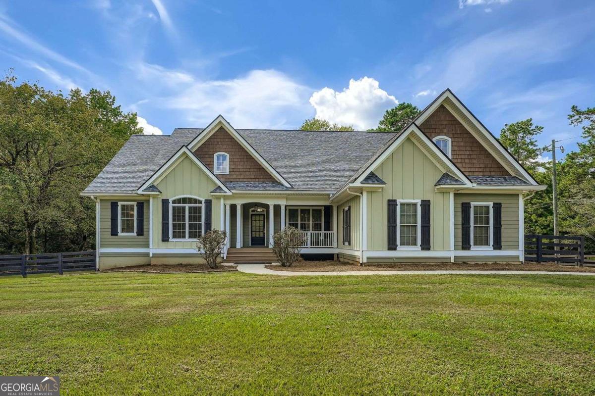 Beautiful and Private Mini-Estate in Milton on 1.4 acres! Ranch style living with 3 bedrooms on main including the Master, 1 bedroom up which could be an office plus a fully, finished walk-out basement complete with bedroom, full bath, second kitchen (with full size appliances), living room, sitting area, custom office with built-ins and french doors plus a converted third garage set up as a full gym. Basement has eparate entrance ideal for an in-law apartment or rental. Full daylight walk-out to huge manicured corner lot! Inviting front porch opens to foyer and oversized separate dining room which seats 12+ has a beautiful elevated trey ceiling. View to fireside living room with coffered ceilings and wall of built-in shelving. Gourmet kitchen has an additional fireside keeping area, bar space, island, custom cabinets, pantry, stainless appliances, granite counters, upgraded lighting and eat-in area with built-in bench. Kitchen has wainscoating throughout. Walk out to covered deck that overlooks the private fenced backyard. Oversized master bedroom with private door to outdoor porch, his/hers master closets, vaulted trey ceilings. Spa-like master bath with updated separate spa tub and tiled shower. Spacious secondary bedrooms. Newly painted inside and out. Newer roof. No HOA. Fully fenced in private backyard with shed for storage. Hardwoods on main areas, with beautiful crown mouldings and carpet in bedrooms.