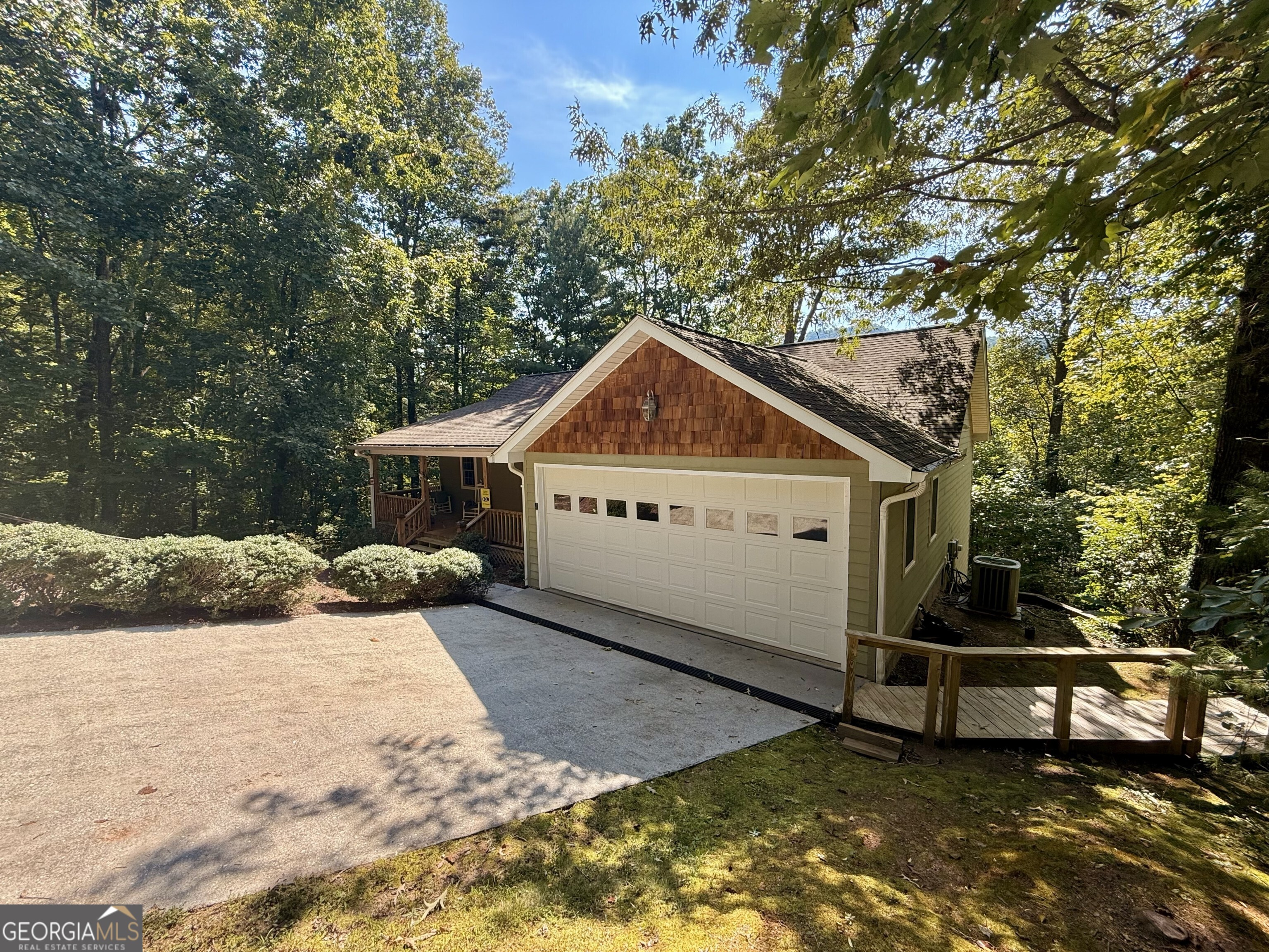 Intown living awaits at this 4 bedroom 3 bathroom home within the city limits of Clayton, Georgia! A paved private road leads to the property. Step inside to an open floor plan with combined kitchen, living and dining areas. Two guest bedrooms and a shared bath are located to the left of the front entrance. The main bedroom and bathroom also on the main level are off the right side of the house along with the laundry room and interior entrance to the garage. Downstairs, you'll find an additional spacious living area with second kitchen, bedroom and bathroom. A covered porch off of the kitchen allows for views facing Screamer Mountain off the back of the house. A lower porch allows separate entry to the lower level living space and the fenced back yard. Located within a brisk walk to downtown Clayton and just far enough away for peace and quiet. This property is ideally suited for full time, second home or even short term rental use. Located only minutes from Pinnacle Knob trail, Warwoman Dell and all of the amenities of downtown Clayton including restaurants, shopping and groceries.
