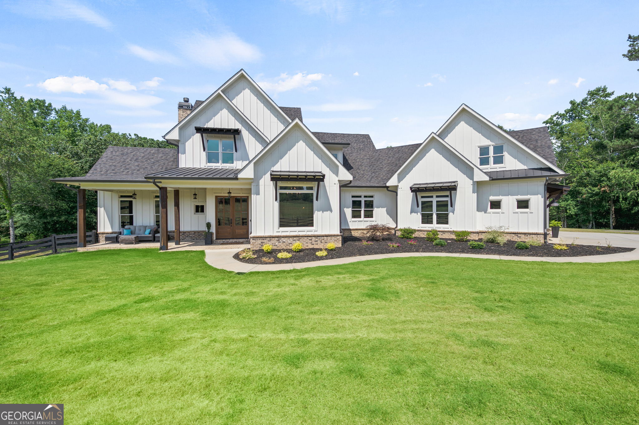 Welcome to Southern Grace Equestrian Center, home for for the discriminating horse enthusiast. From the moment you enter the light filled property you will realize how meticulously this estate has been designed with the horse enthusiast in mind. There are 2 long picturesque gated driveways- one to the home and one to the stable facilities. Every detail to this estate has been carefully planned and thought out. When you enter the 5 bedroom charming (almost new) farm house you will be stunned by the beautiful reclaimed hardwoods on the main level that are over 100 years old. The gourmet kitchen has all the whistles and bells and is open to the family room that adjoins the large screened porch and looks out to the gorgeous salt water pool with a full outdoor kitchen for all your entertainment needs. Beyond the pool is a pond where you will love watching your horses play and frolic. The Master bedroom is on the main level and also opens to the amazing pool area. The office is also on the main level and you an enjoy the views of the lush pastures and happy horses from the panoramic windows. All upstairs bedrooms are large and airy. The terrace level is delightful and feature an additional guest bedroom, bathroom, game room and bar. Now let's head up the second driveway to the 38 stall barn with large parking area that will accommodate many horse trailers and is a perfect venue for riding clinics. Very well insulated and ventilated with 2 tack rooms, multiple wash racks, feed rooms and a large outdoor arena with lights. There is a separate building with 2/3 additional stalls and shaving storage.